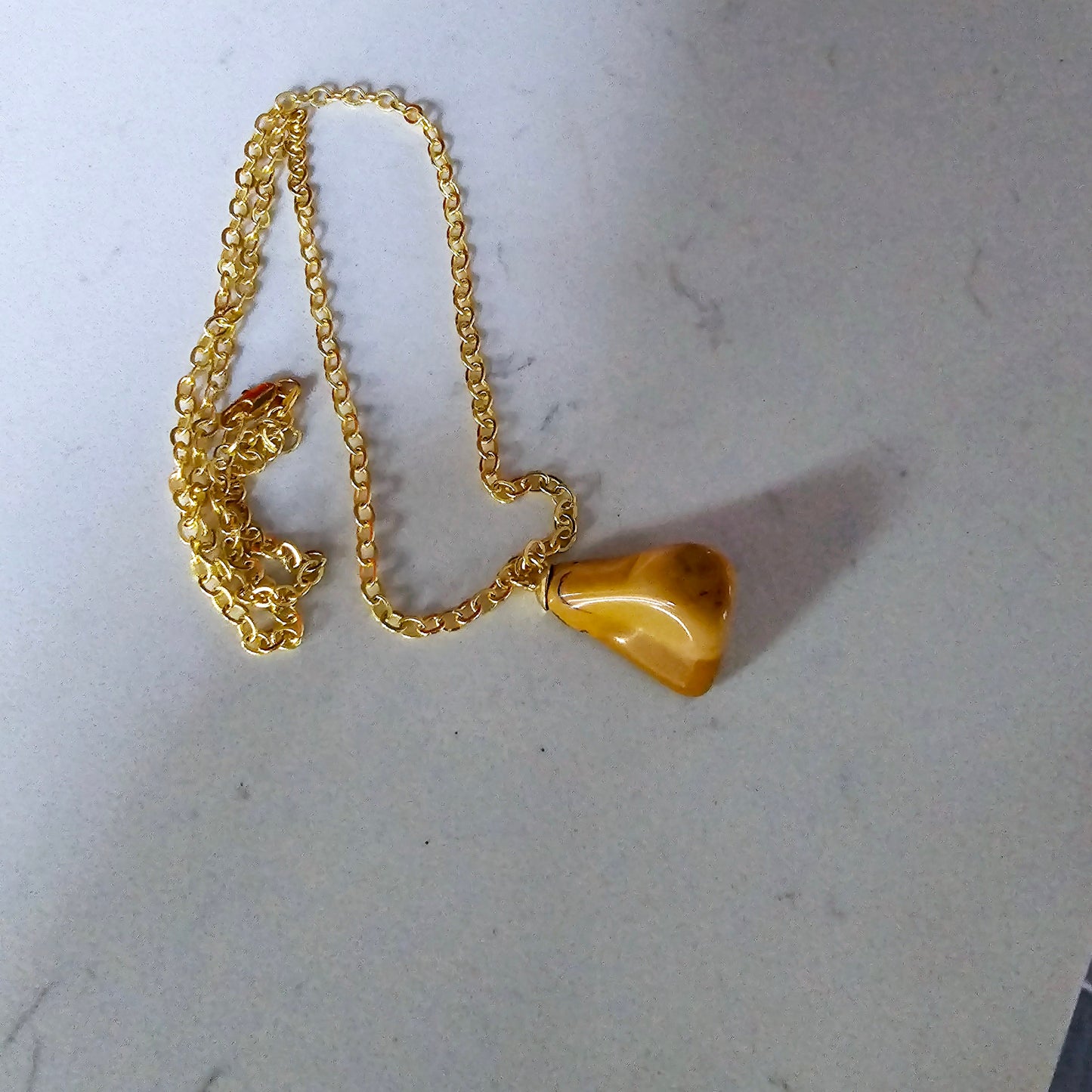 Uniquely shaped Yellow Jasper Pendant. This bold pendant is trimmed with gold-plated findings and gold-plated 20" chain