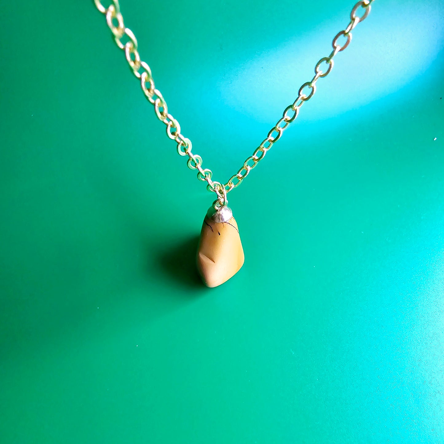 Uniquely shaped Yellow Jasper Pendant. This bold pendant is trimmed with gold-plated findings and gold-plated 20" chain