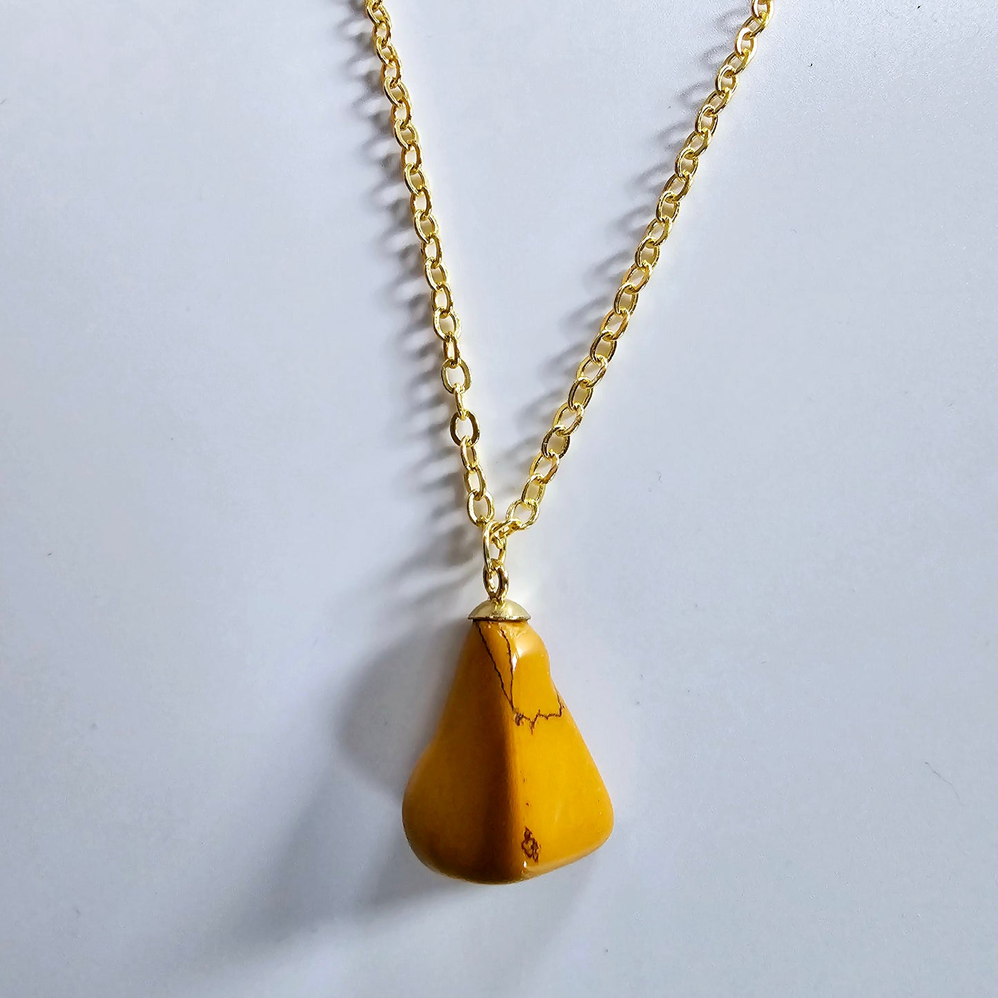 Uniquely shaped Yellow Jasper Pendant. This bold pendant is trimmed with gold-plated findings and gold-plated 20" chain