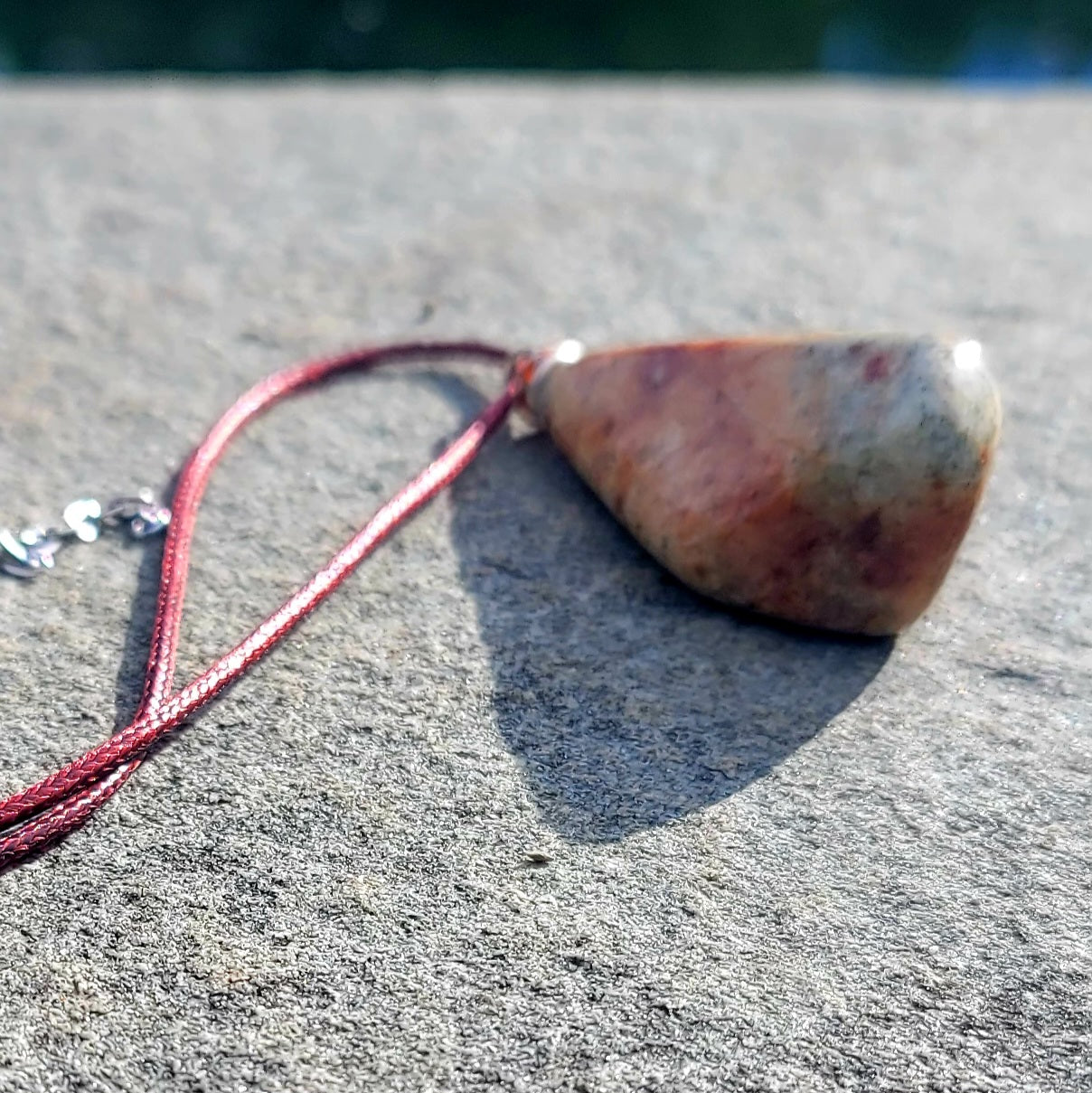 Very unique and powerful sunstone pendant. This stone has an intriguing color pattern consisting of Reds, Oranges, Green and Brown. It also has a unique shape that will definitely stand out. This is a true one-of-a-kind piece.