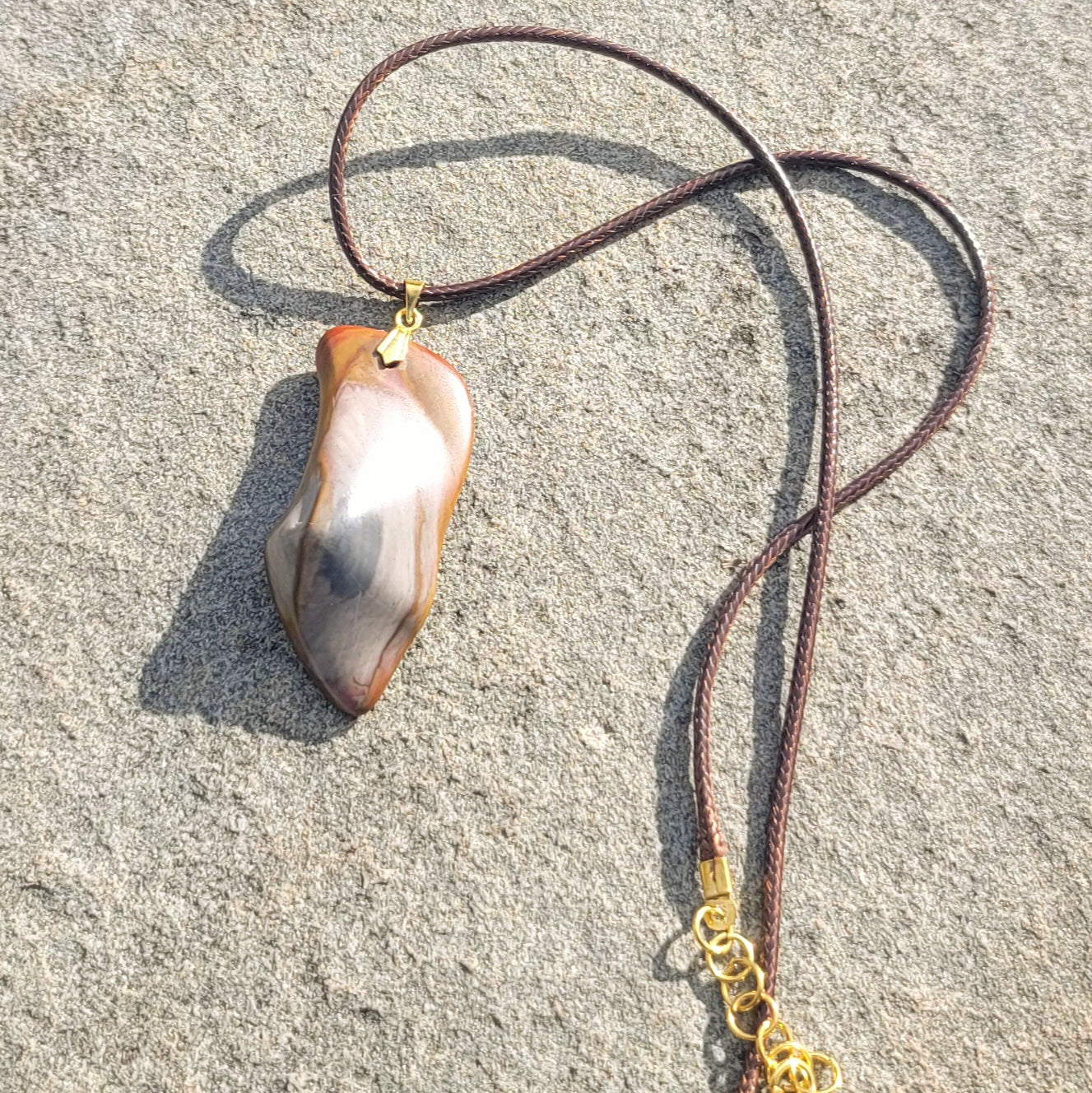 ONE-OF-A-KIND POLYCHROMEJASPERPENDANT.This irregularly shaped pendant will allow you to stand out and stake your claim as a trendsetter. It will leave an impression, anywhere. It is versatile enough to go with any color scheme.