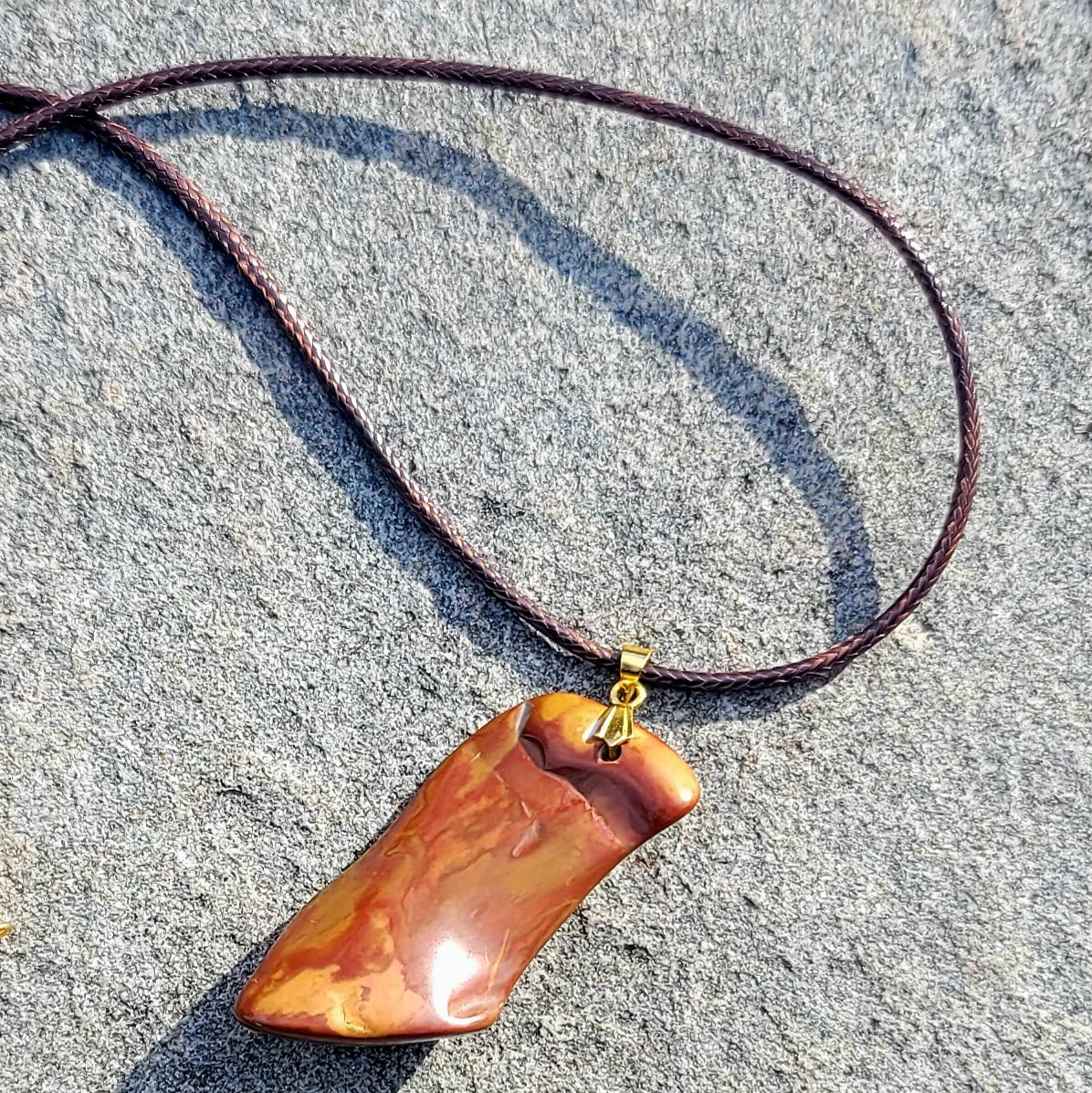 ONE-OF-A-KIND POLYCHROMEJASPERPENDANT.This irregularly shaped pendant will allow you to stand out and stake your claim as a trendsetter. It will leave an impression, anywhere. It is versatile enough to go with any color scheme.