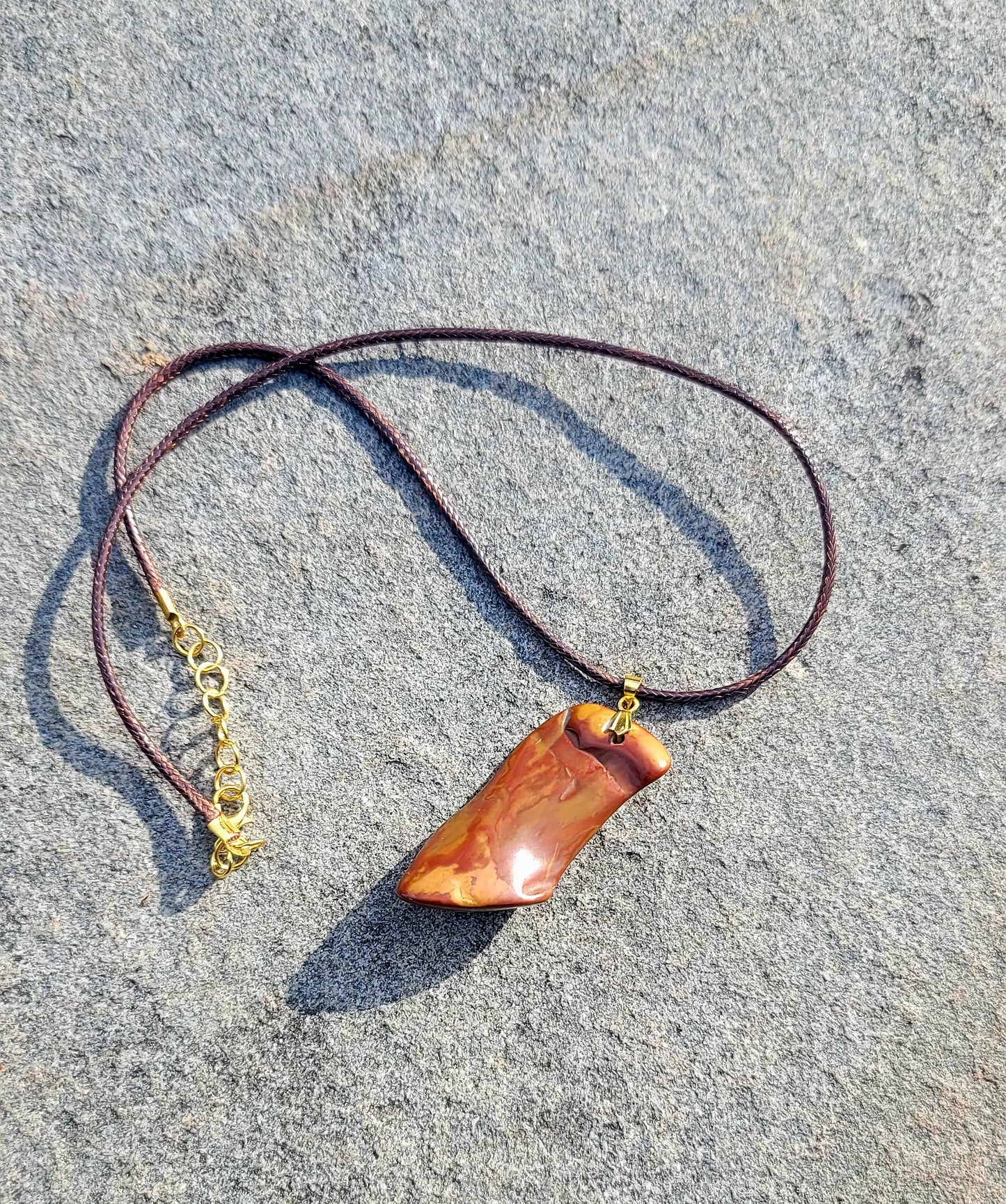 ONE-OF-A-KIND POLYCHROMEJASPERPENDANT.This irregularly shaped pendant will allow you to stand out and stake your claim as a trendsetter. It will leave an impression, anywhere. It is versatile enough to go with any color scheme.