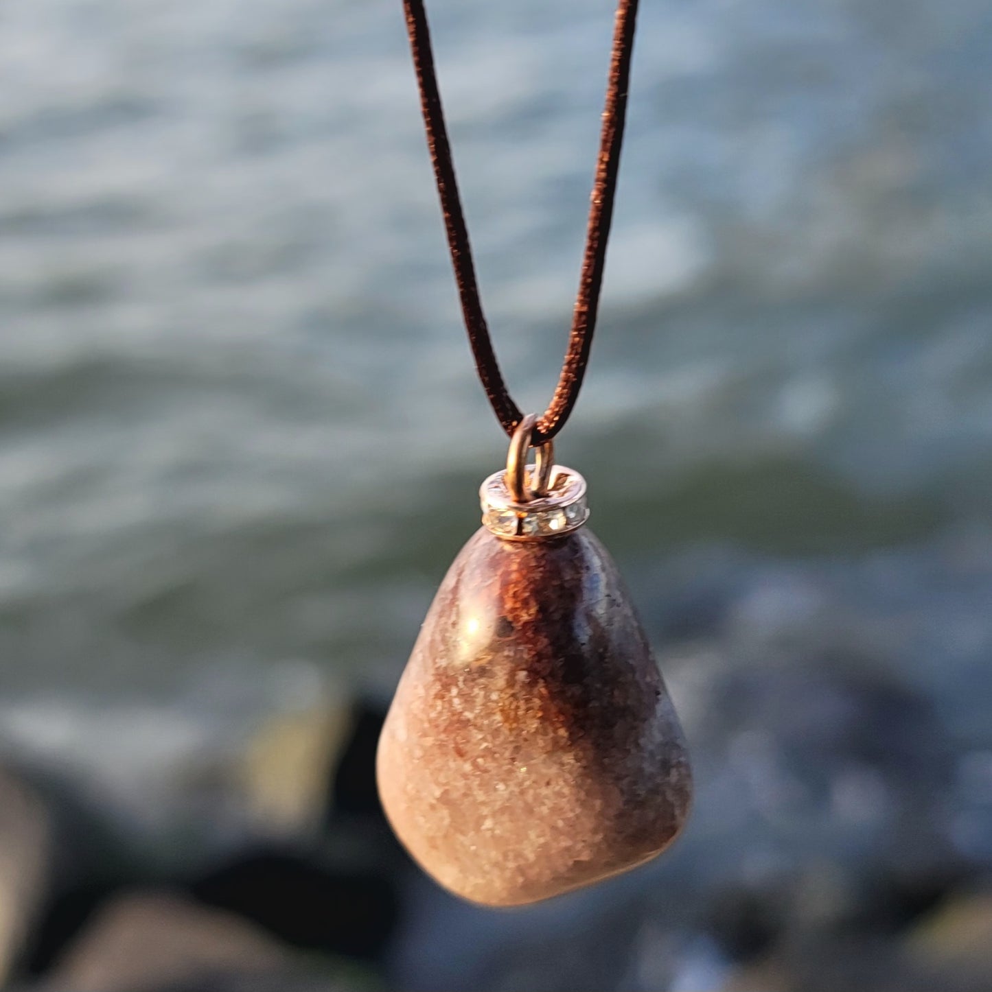 Mesmerizing Strawberry Quartz pendant. Hold it up to reveal what looks like strawberry seeds suspended in glass. Great piece for you or as a gift to someone special