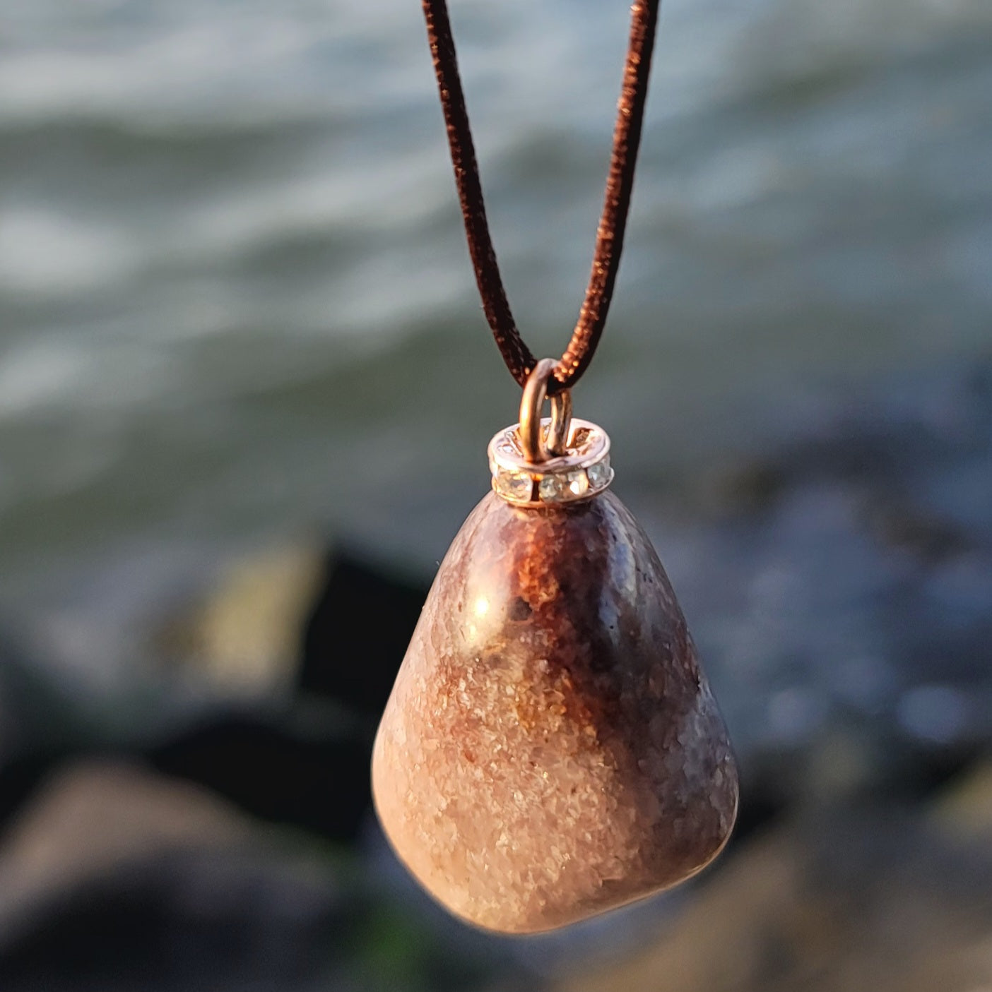 Mesmerizing Strawberry Quartz pendant. Hold it up to reveal what looks like strawberry seeds suspended in glass. Great piece for you or as a gift to someone special