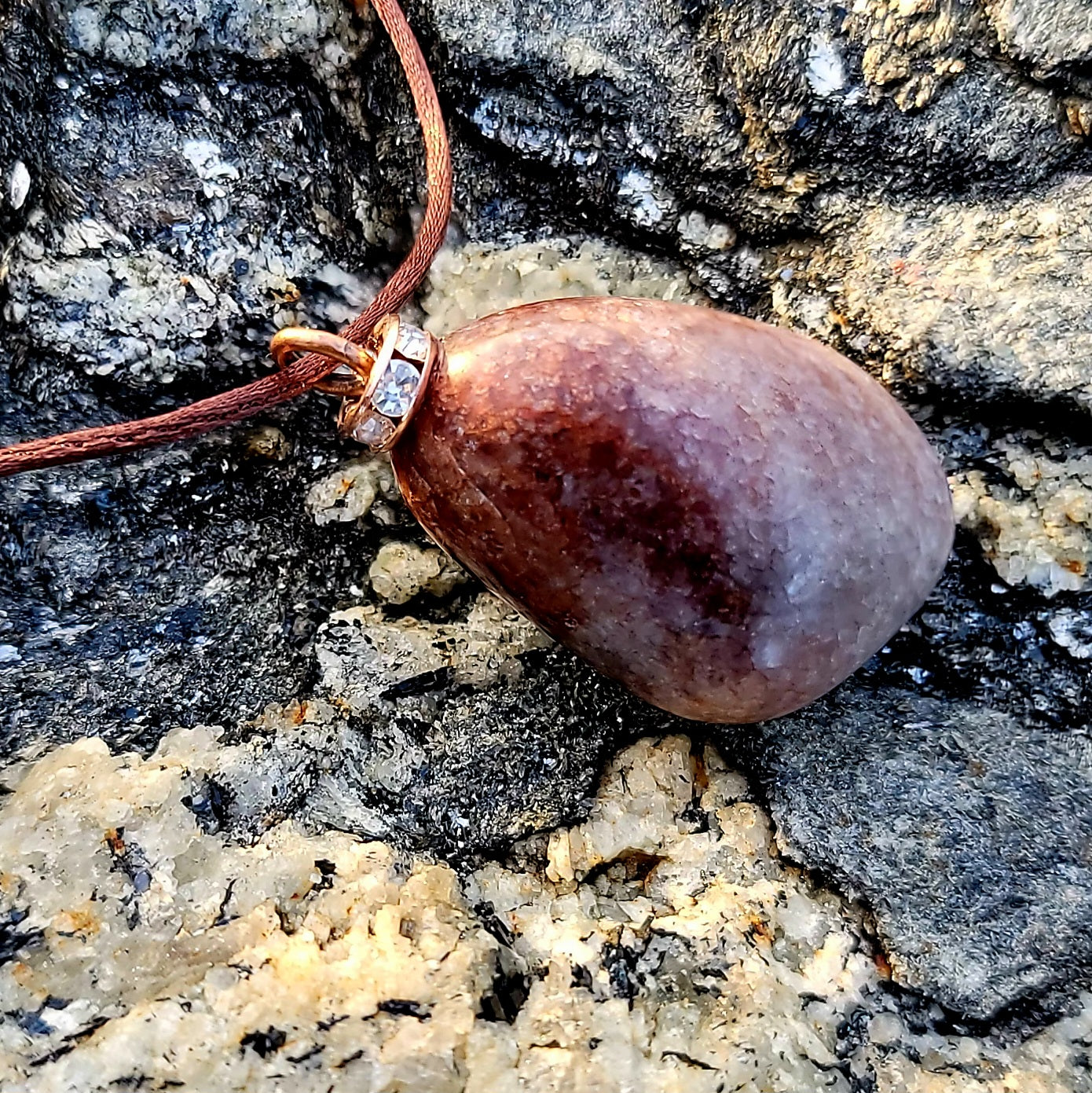 Mesmerizing Strawberry Quartz pendant. Hold it up to reveal what looks like strawberry seeds suspended in glass. Great piece for you or as a gift to someone special