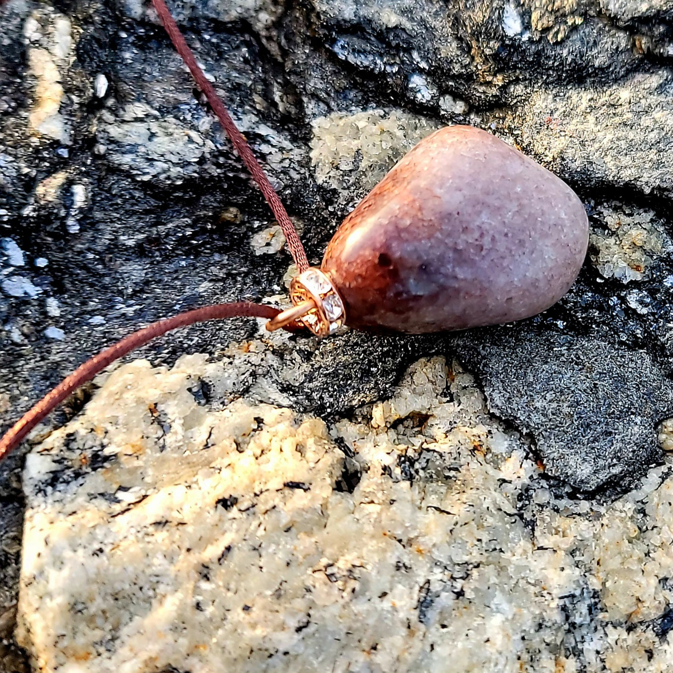 Mesmerizing Strawberry Quartz pendant. Hold it up to reveal what looks like strawberry seeds suspended in glass. Great piece for you or as a gift to someone special