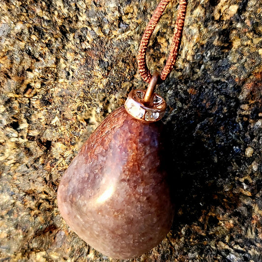 Mesmerizing Strawberry Quartz pendant. Hold it up to reveal what looks like strawberry seeds suspended in glass. Great piece for you or as a gift to someone special