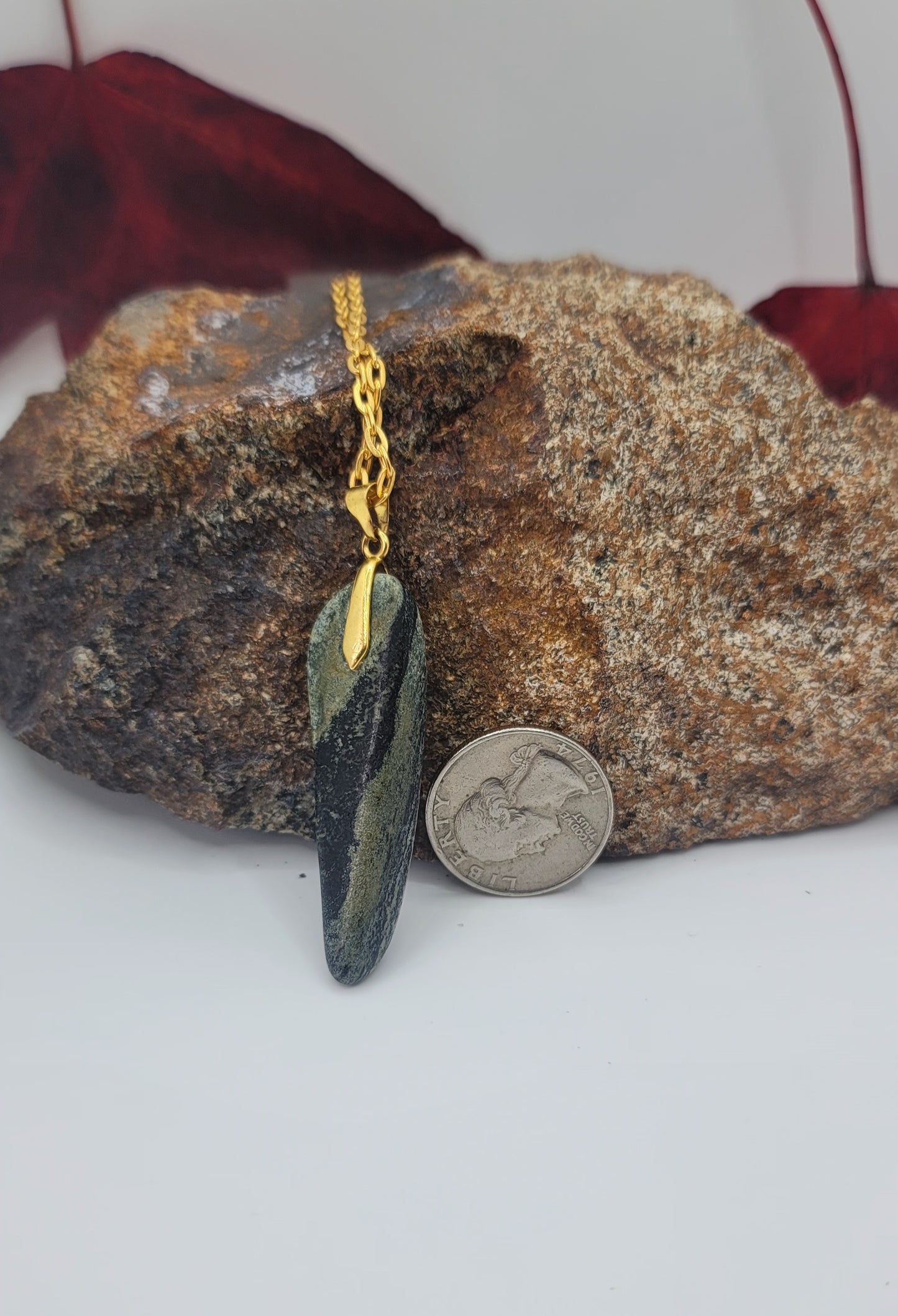 THIS YELLOW-GREEN SERPENTINE GEMSTONE PENDANT IS SURE TO DELIGHT.