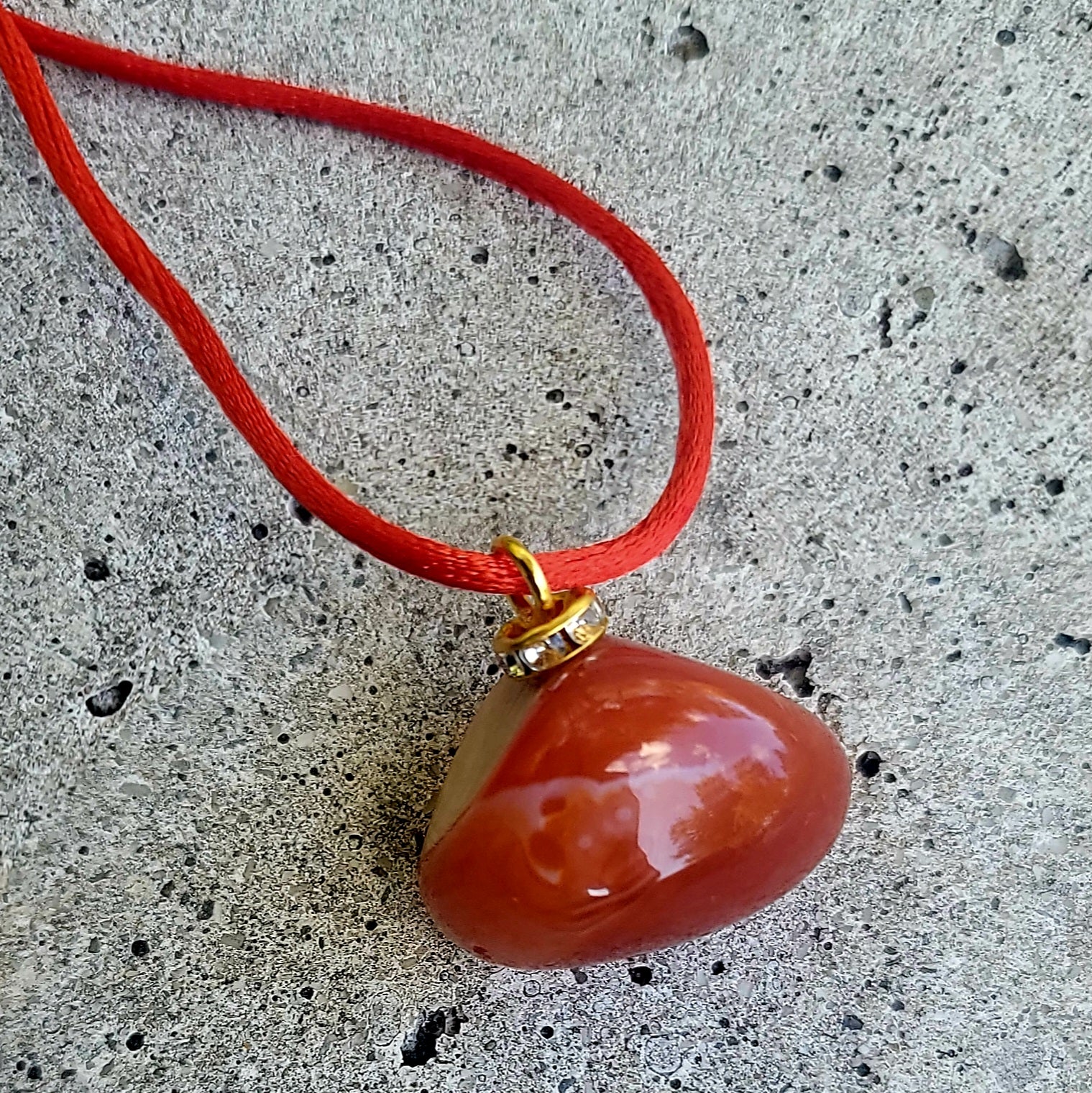 This is an intriguing and Beautiful Carnelian Agate Pendant. It is trimmed with a 20" Polyester string.