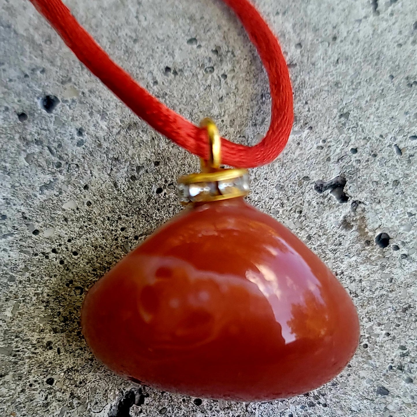 This is an intriguing and Beautiful Carnelian Agate Pendant. It is trimmed with a 20" Polyester string.