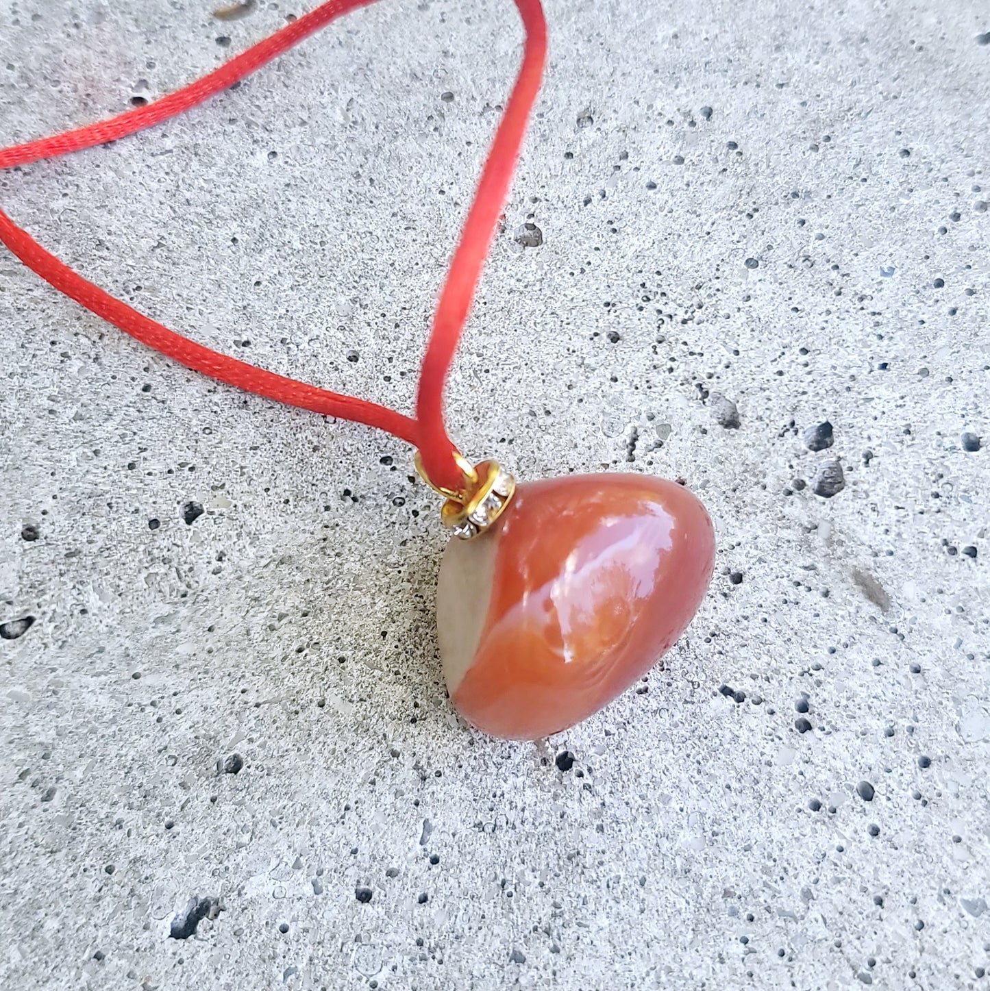 This is an intriguing and Beautiful Carnelian Agate Pendant. It is trimmed with a 20" Polyester string.