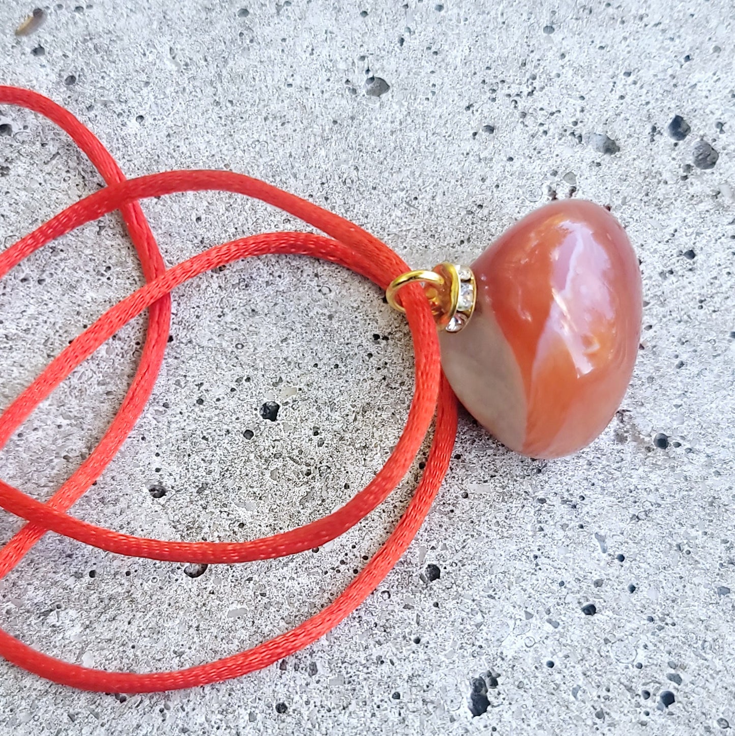 This is an intriguing and Beautiful Carnelian Agate Pendant. It is trimmed with a 20" Polyester string.