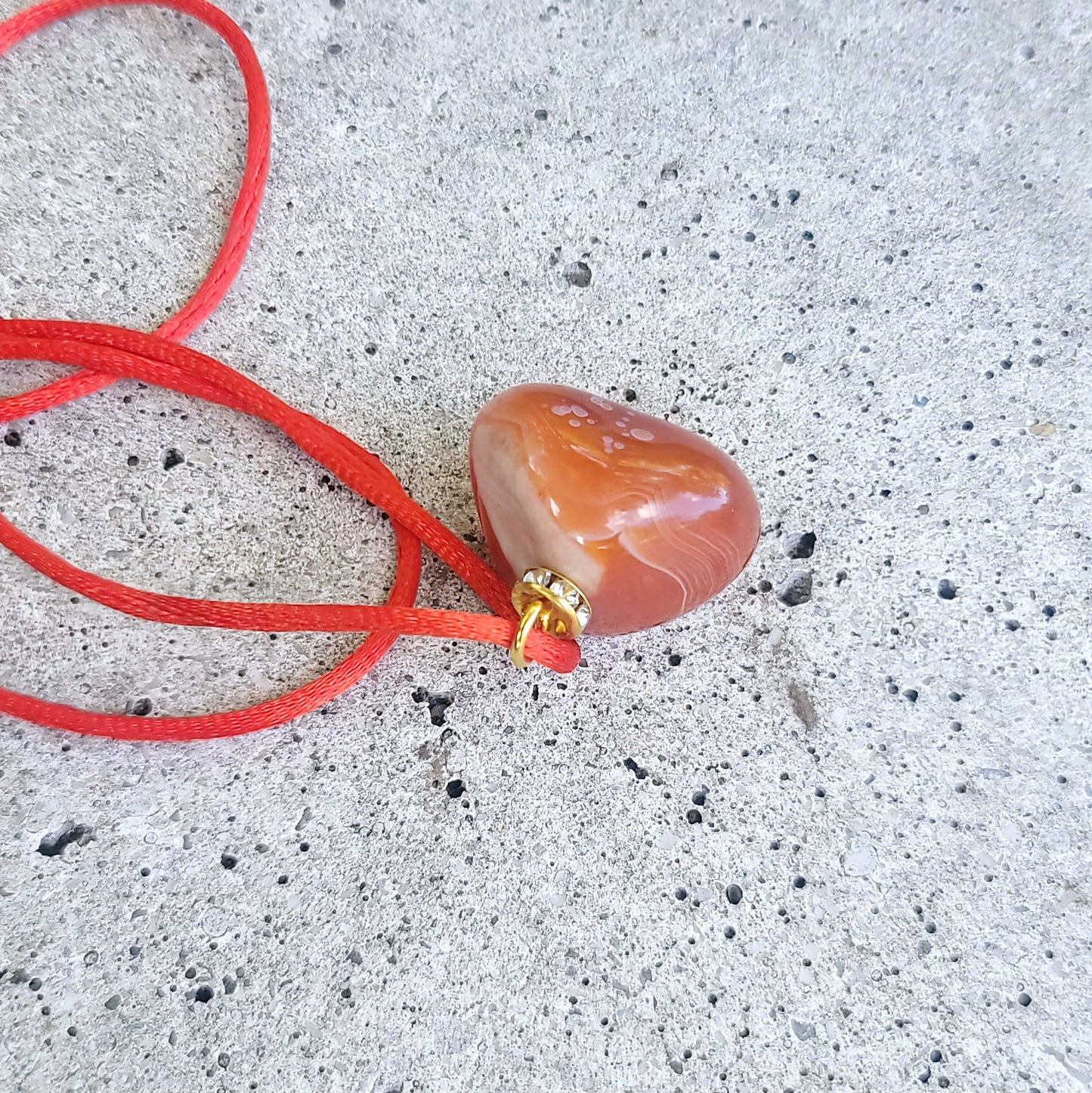 This is an intriguing and Beautiful Carnelian Agate Pendant. It is trimmed with a 20" Polyester string.