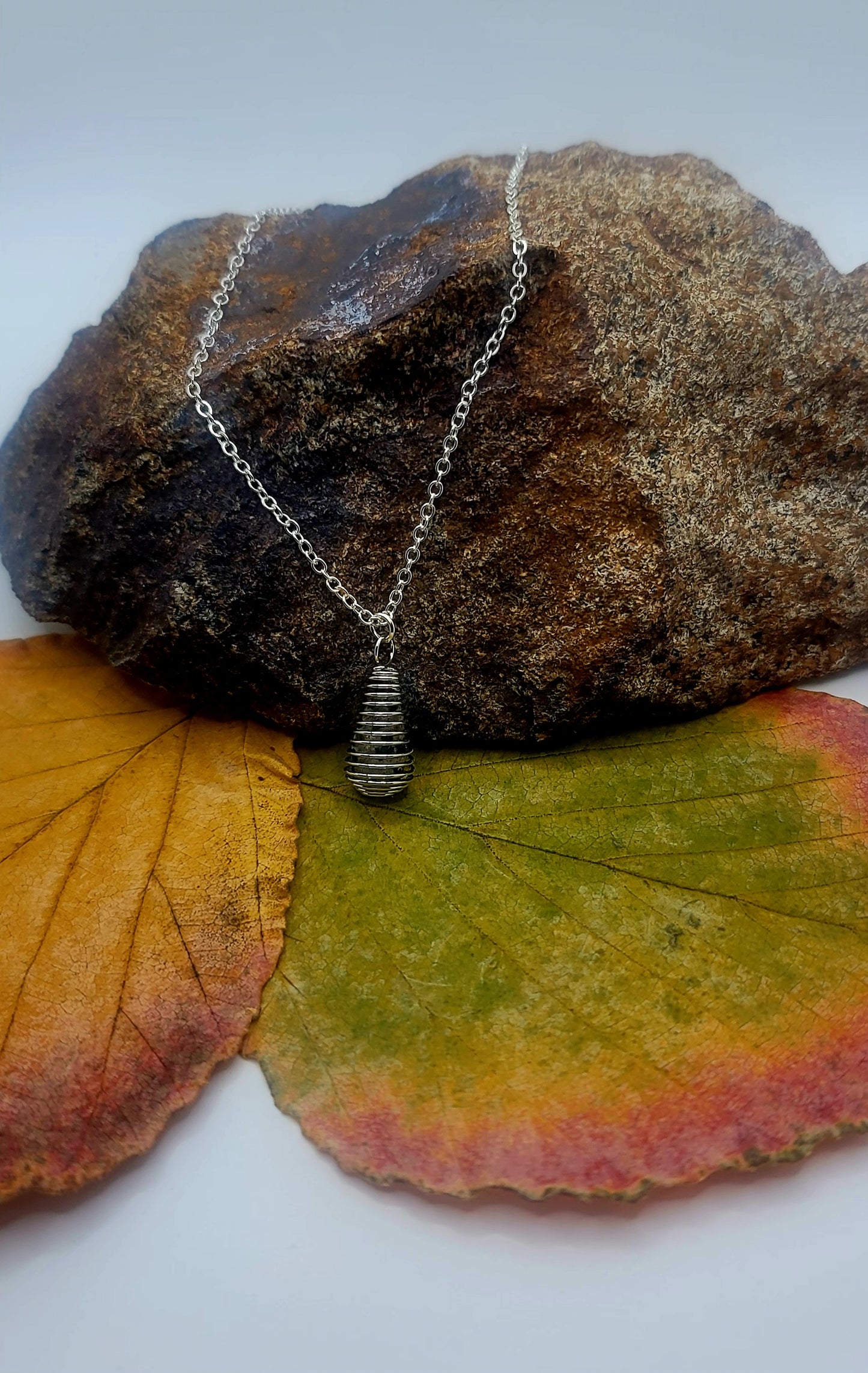 Cute Spiral cage Dalmation Stone necklace. This petite but unique piece is perfect for the women in your life. Get it now for mom, Sister, Aunt or Girlfriend.