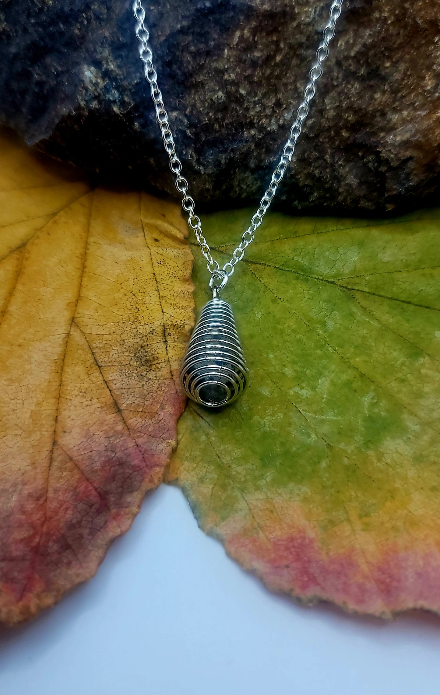 Cute Spiral cage Dalmation Stone necklace. This petite but unique piece is perfect for the women in your life. Get it now for mom, Sister, Aunt or Girlfriend.