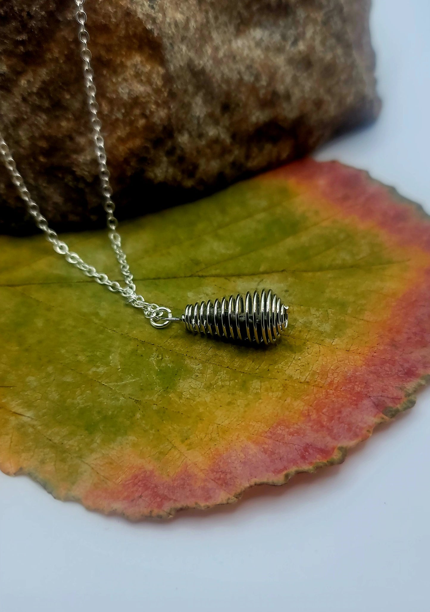 Cute Spiral cage Dalmation Stone necklace. This petite but unique piece is perfect for the women in your life. Get it now for mom, Sister, Aunt or Girlfriend.