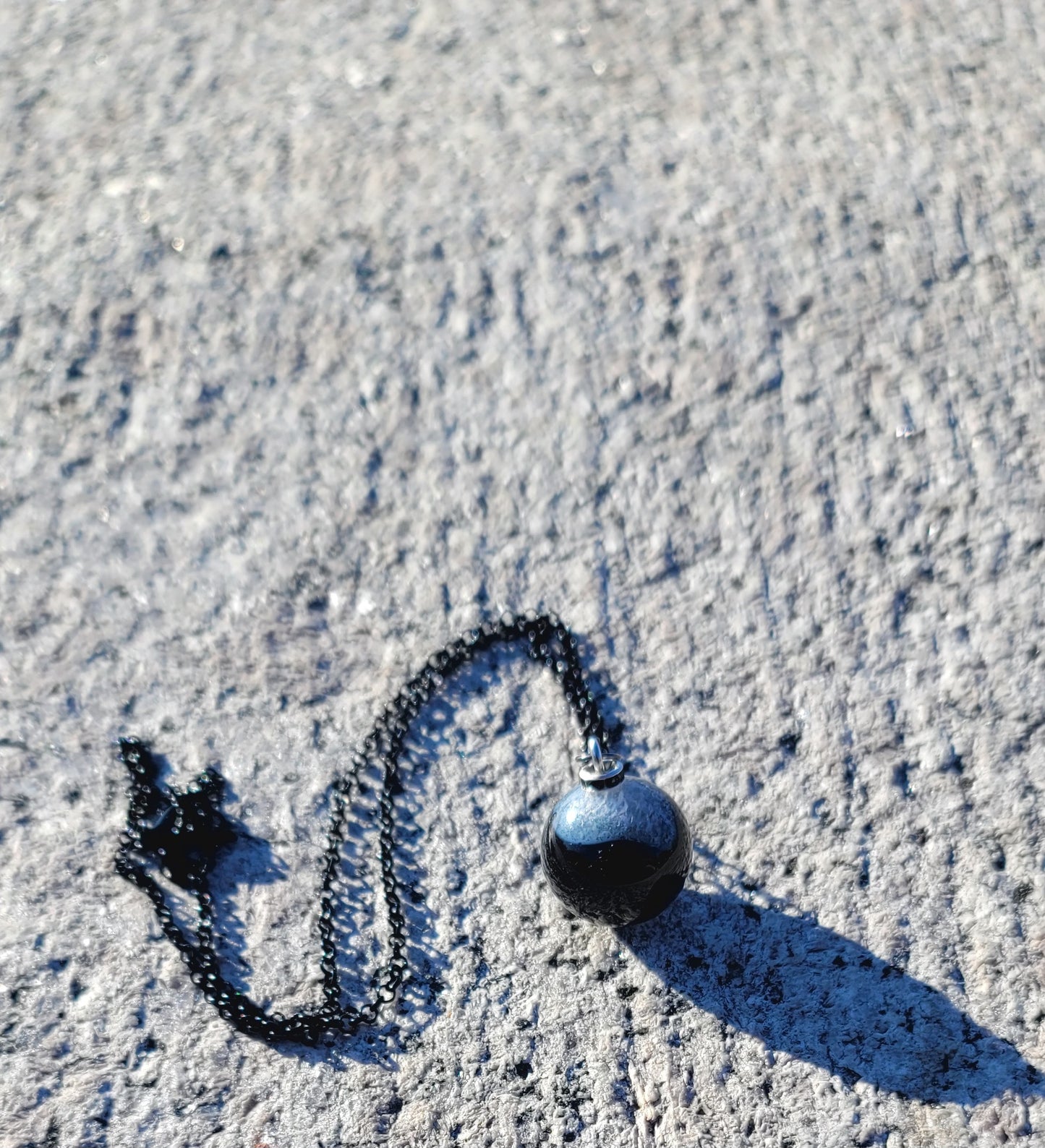 STRIKING COMBINATION BLACK AGATE WITH WHITE QUARTZ PENDANT.