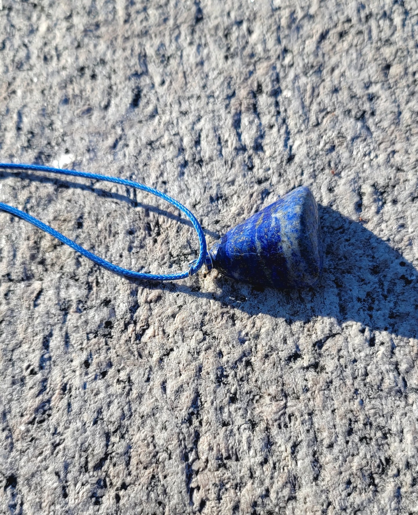 Uniquely shaped Blue Lapis lazuli Pendant necklace. Give this striking blue piece as a gift to that special person in your life. Great for mom or dad, Sis or brother. Perfect for any occasion or taste.