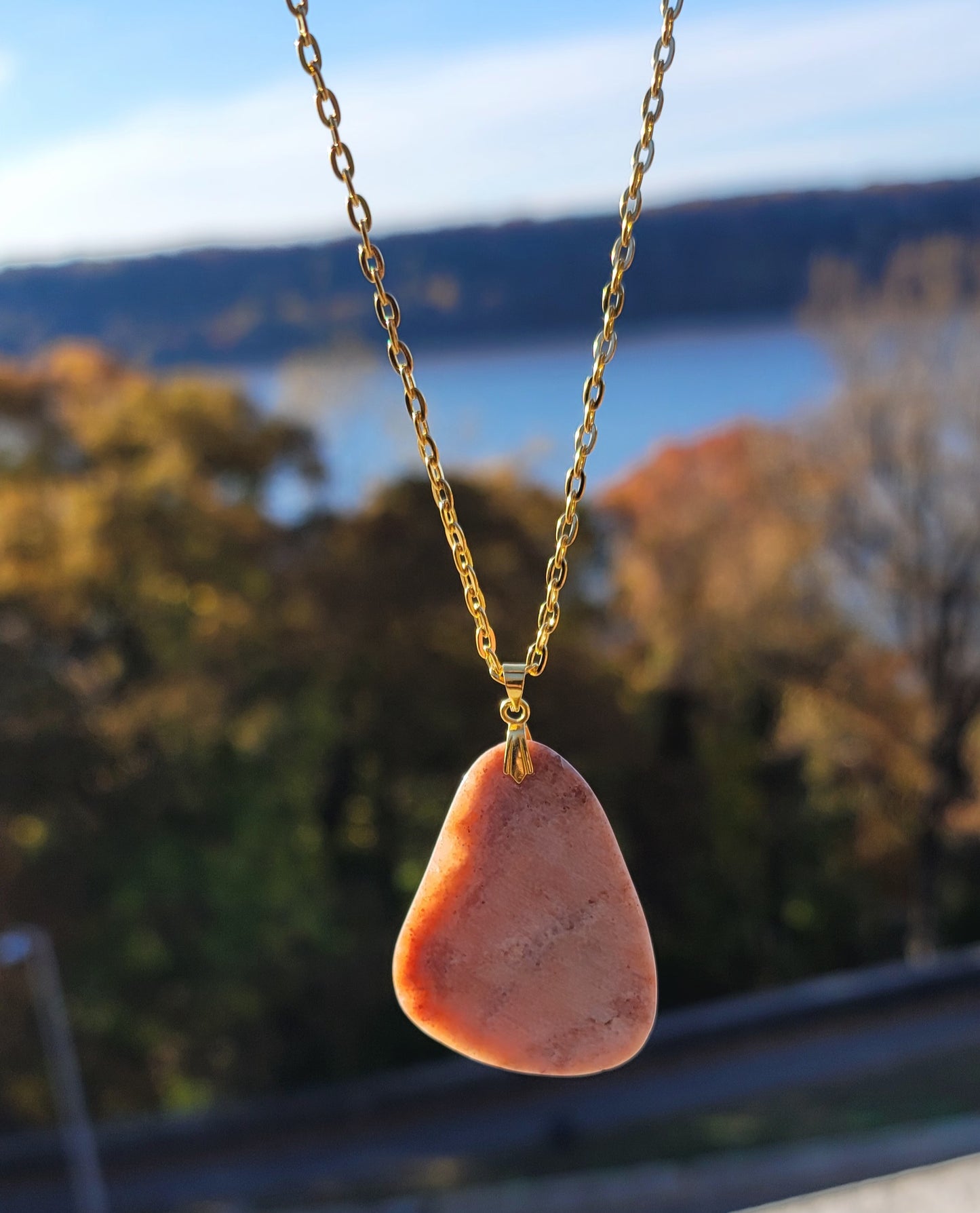 THIS ORANGE & PINK AVENTURINE PENDANT NECKLACE IS SURE TO DELIGHT WITH ITS UNIQUE SHAPE AND COLOR VARIATIONS.