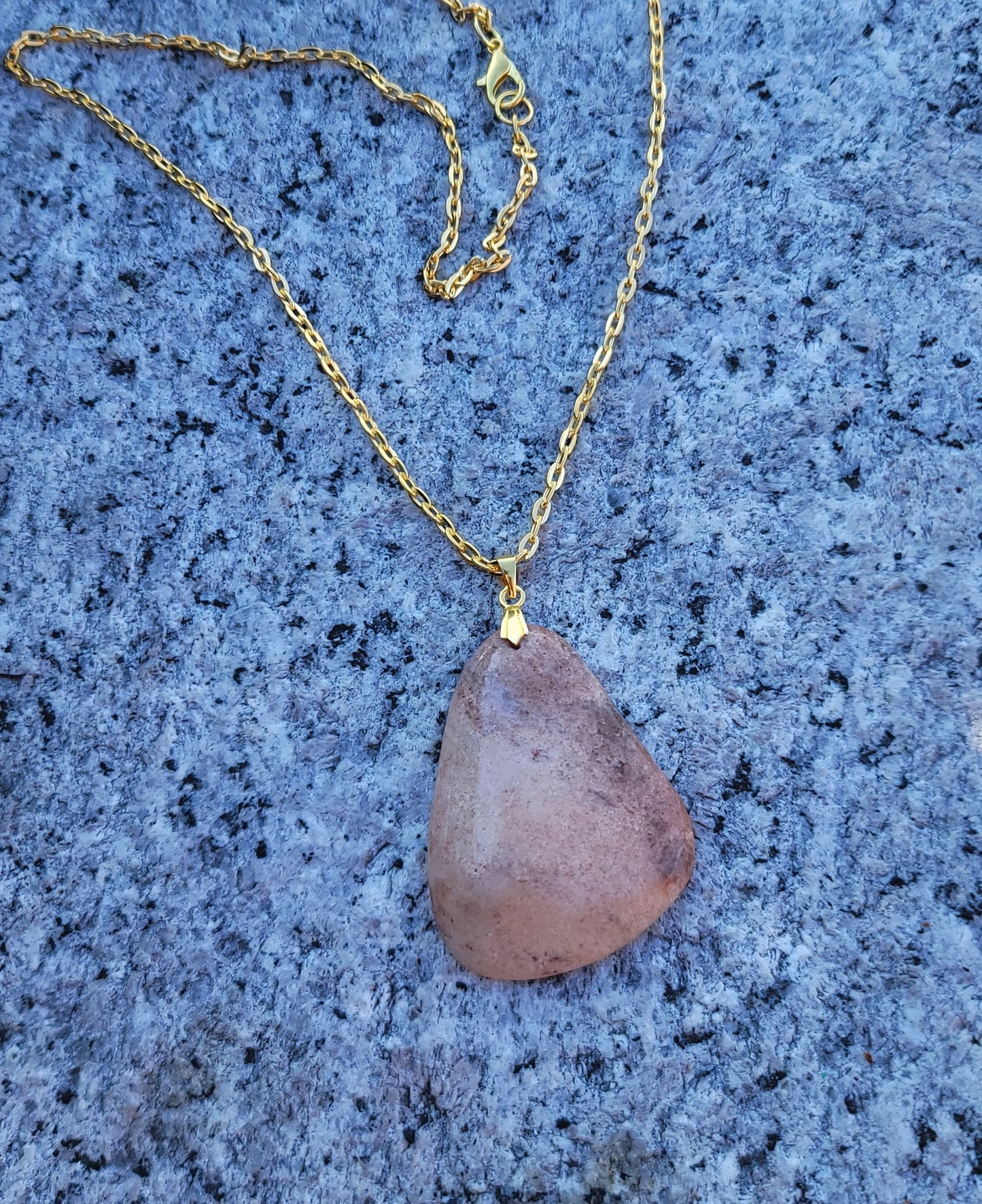 THIS ORANGE & PINK AVENTURINE PENDANT NECKLACE IS SURE TO DELIGHT WITH ITS UNIQUE SHAPE AND COLOR VARIATIONS.