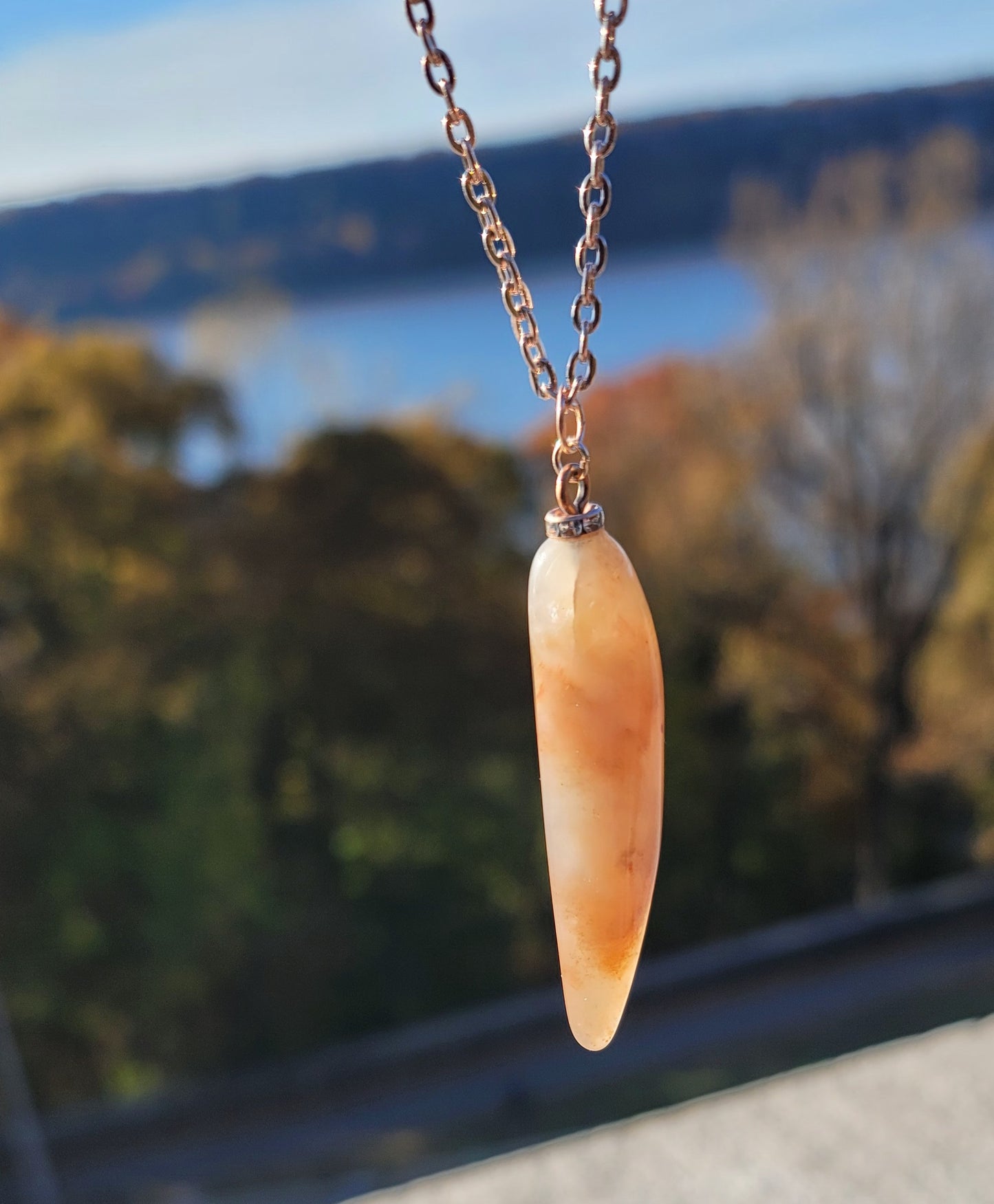 SLEEK FERRUGINOUS QUARTZ PENDANT.