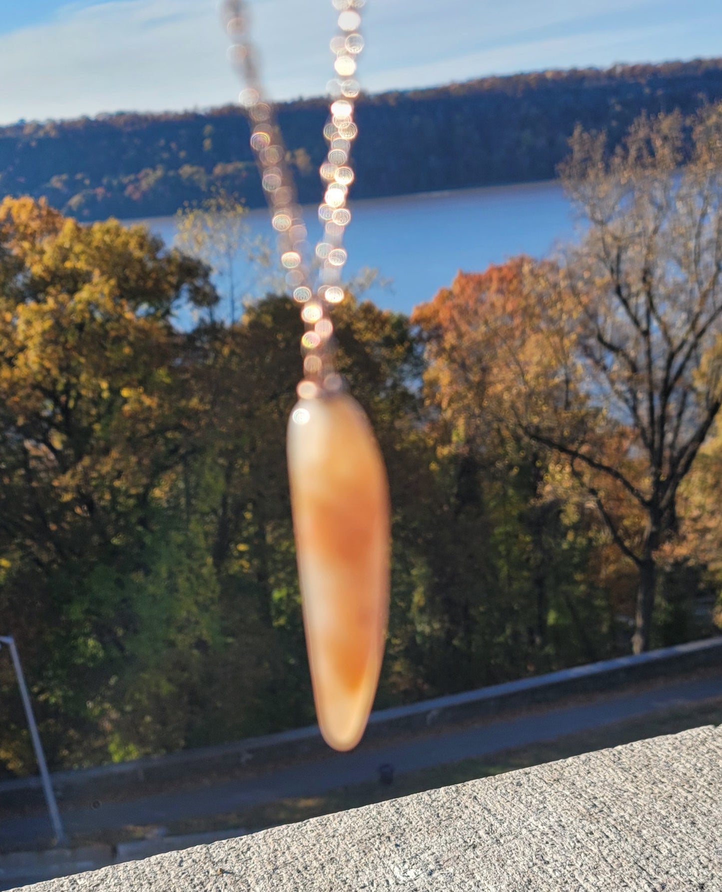 SLEEK FERRUGINOUS QUARTZ PENDANT.