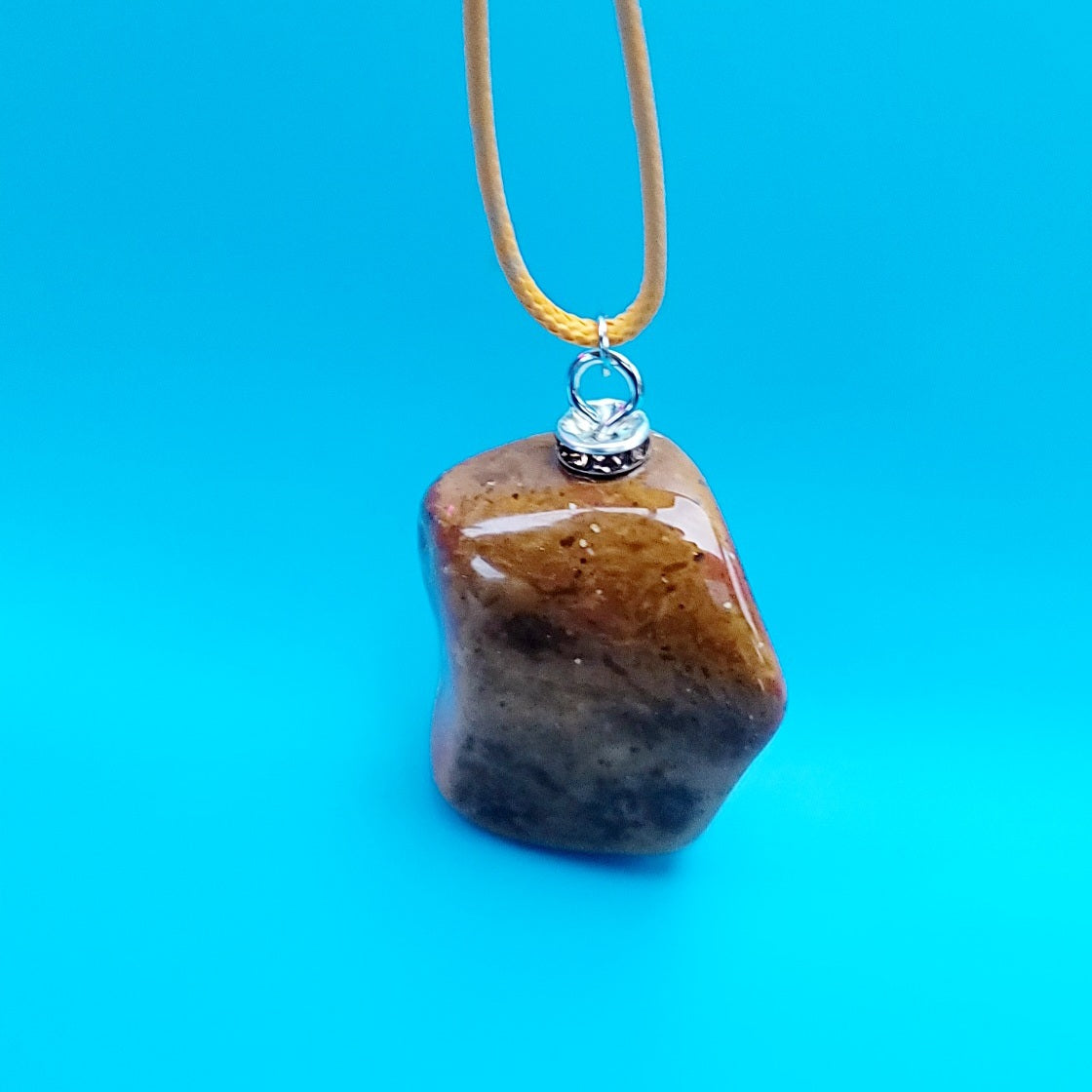 Unique and bold Desert Jasper Pendant with a very intricate color pattern. You will be amazed by its stunning beauty. It is finished with a Yellow Polyester string.