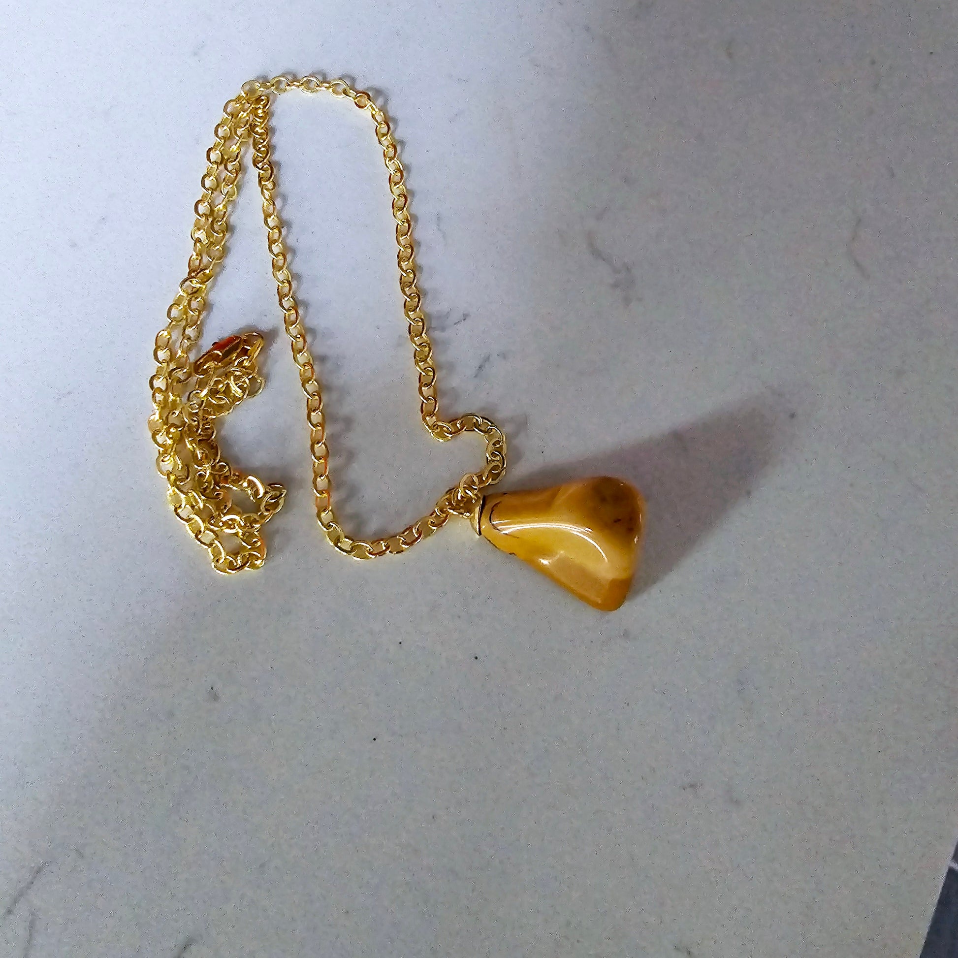 Uniquely shaped Yellow Jasper Pendant. This bold pendant is trimmed with gold-plated findings and gold-plated 20" chain