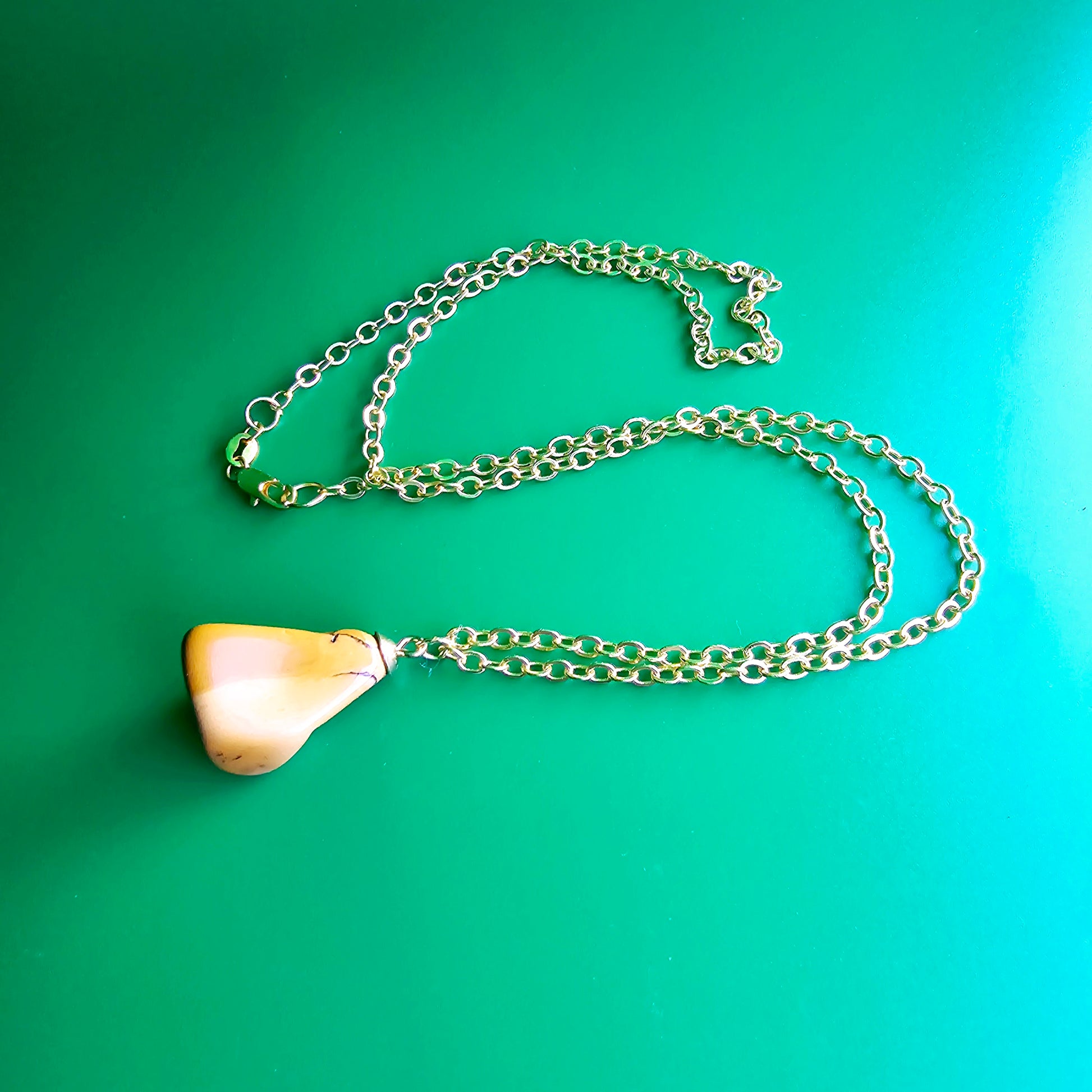 Uniquely shaped Yellow Jasper Pendant. This bold pendant is trimmed with gold-plated findings and gold-plated 20" chain