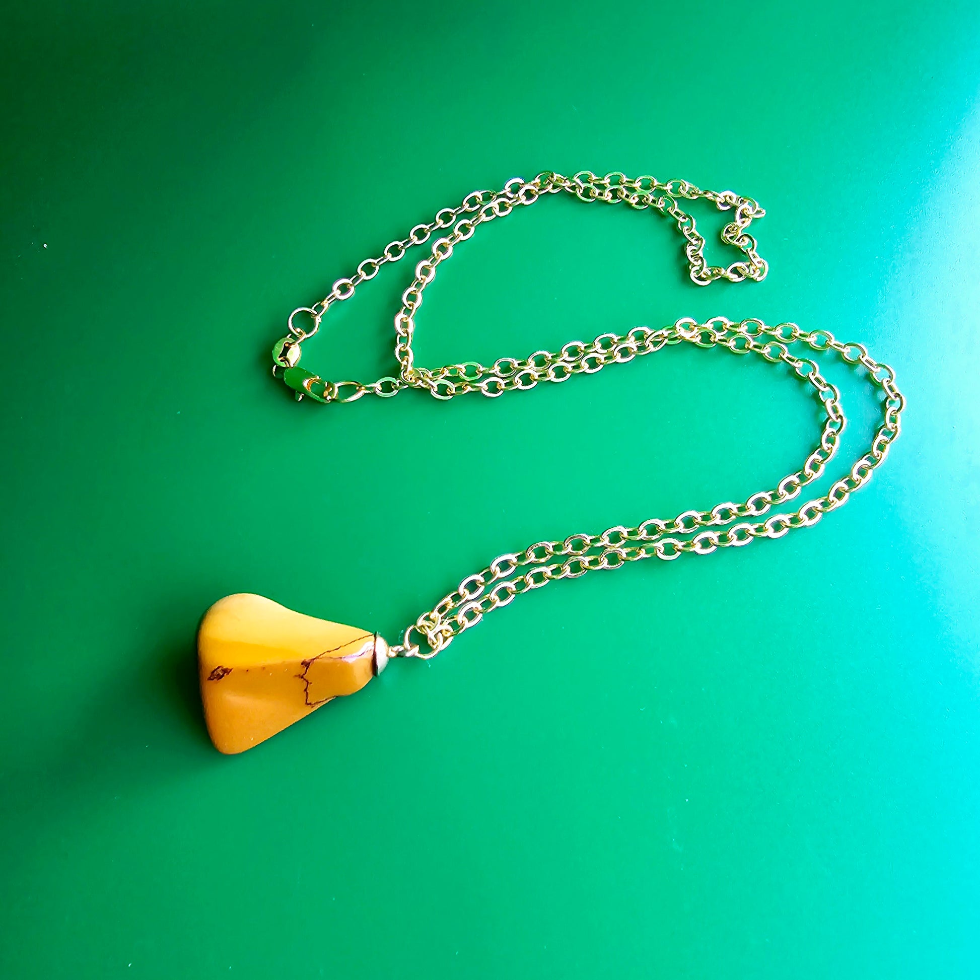 Uniquely shaped Yellow Jasper Pendant. This bold pendant is trimmed with gold-plated findings and gold-plated 20" chain