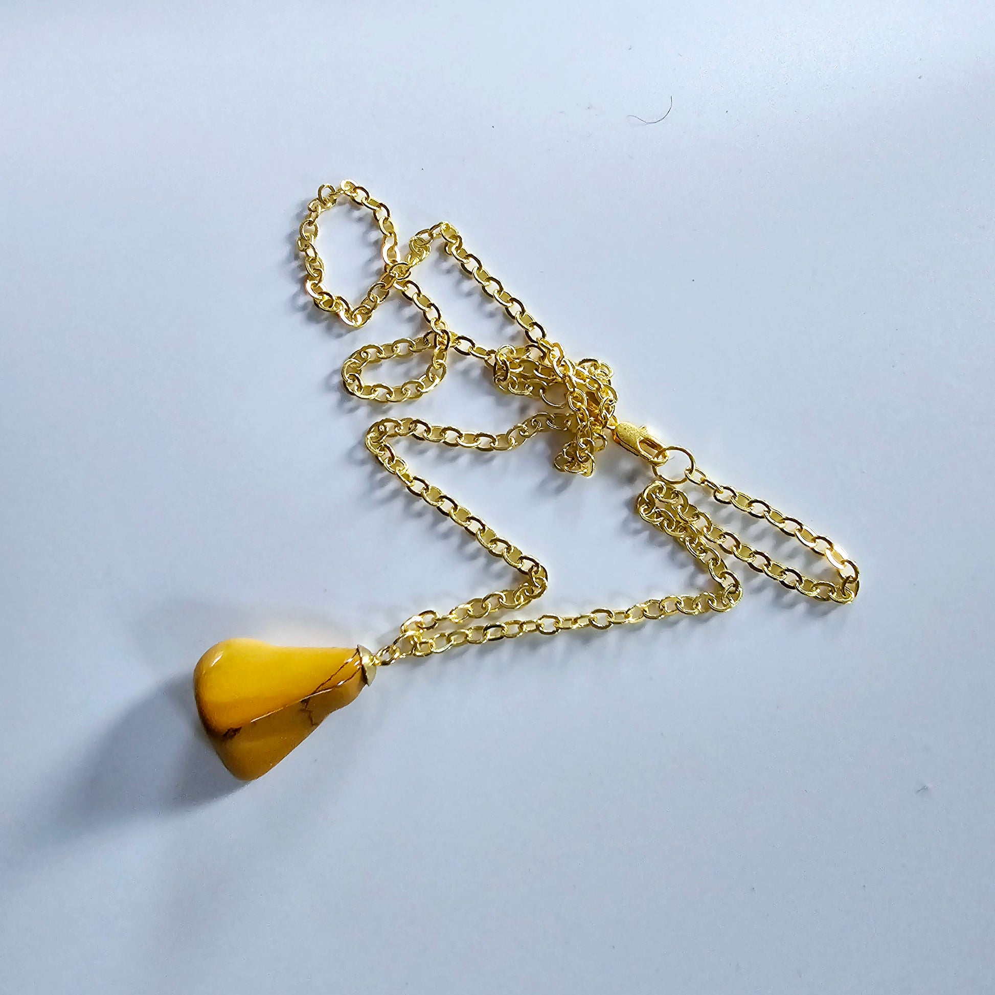 Uniquely shaped Yellow Jasper Pendant. This bold pendant is trimmed with gold-plated findings and gold-plated 20" chain