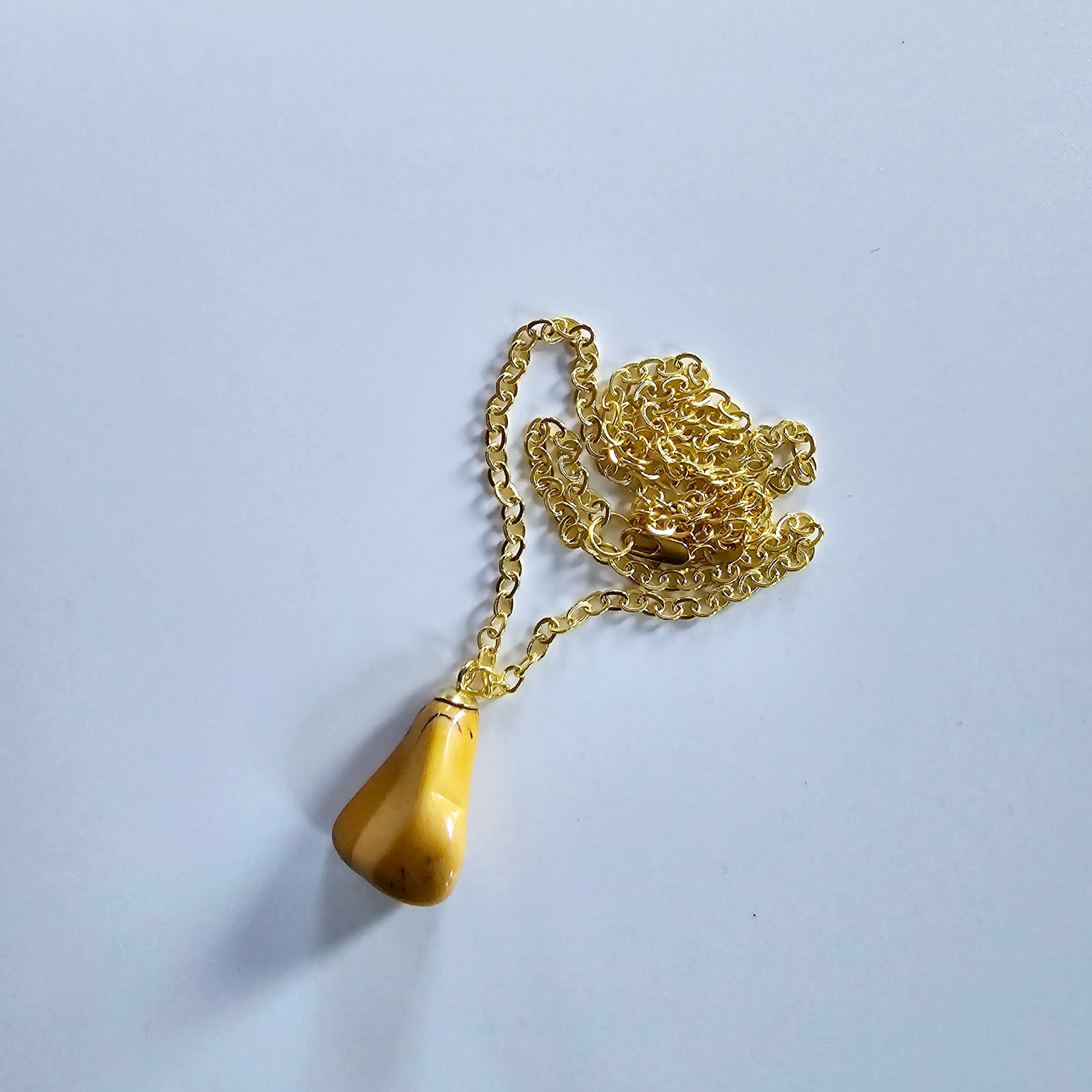 Uniquely shaped Yellow Jasper Pendant. This bold pendant is trimmed with gold-plated findings and gold-plated 20" chain