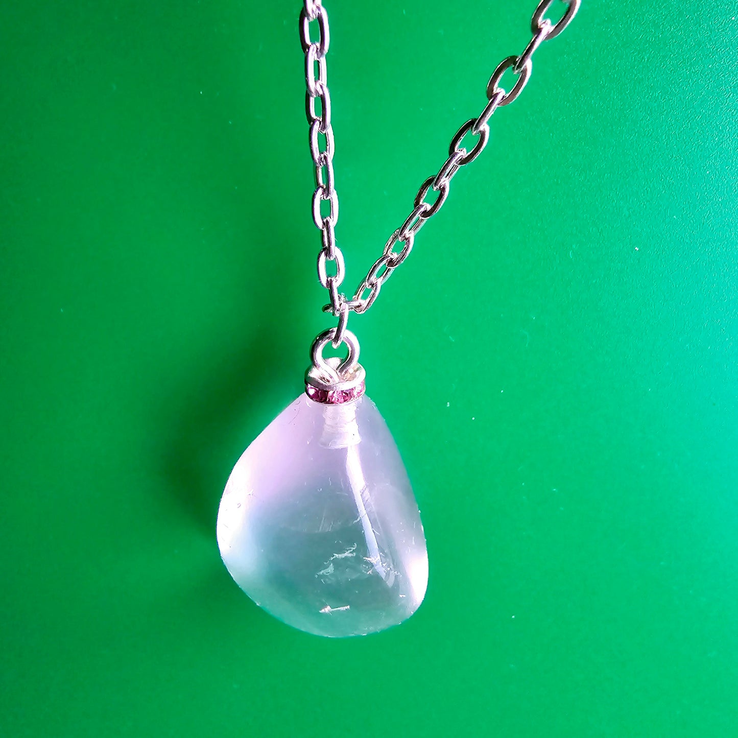 Unique Clear Quartz Pendant that is finished with a 20" Silver-plated chain.