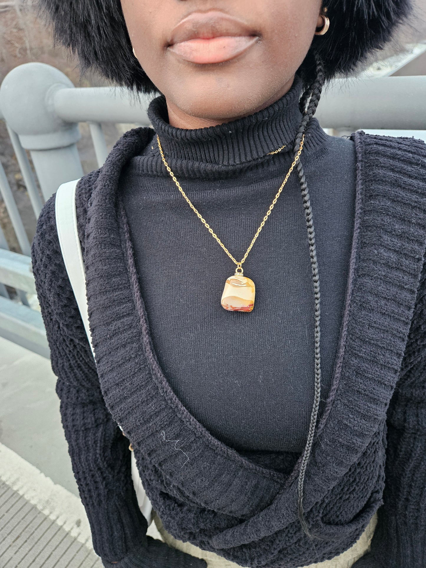 Bold, multicolored Desert Jasper Pendant. This pendant has a vivid color pattern consisting of Yellow, Brown and Purple as the main colors. Lifestyle picture shown of pendant being worn.