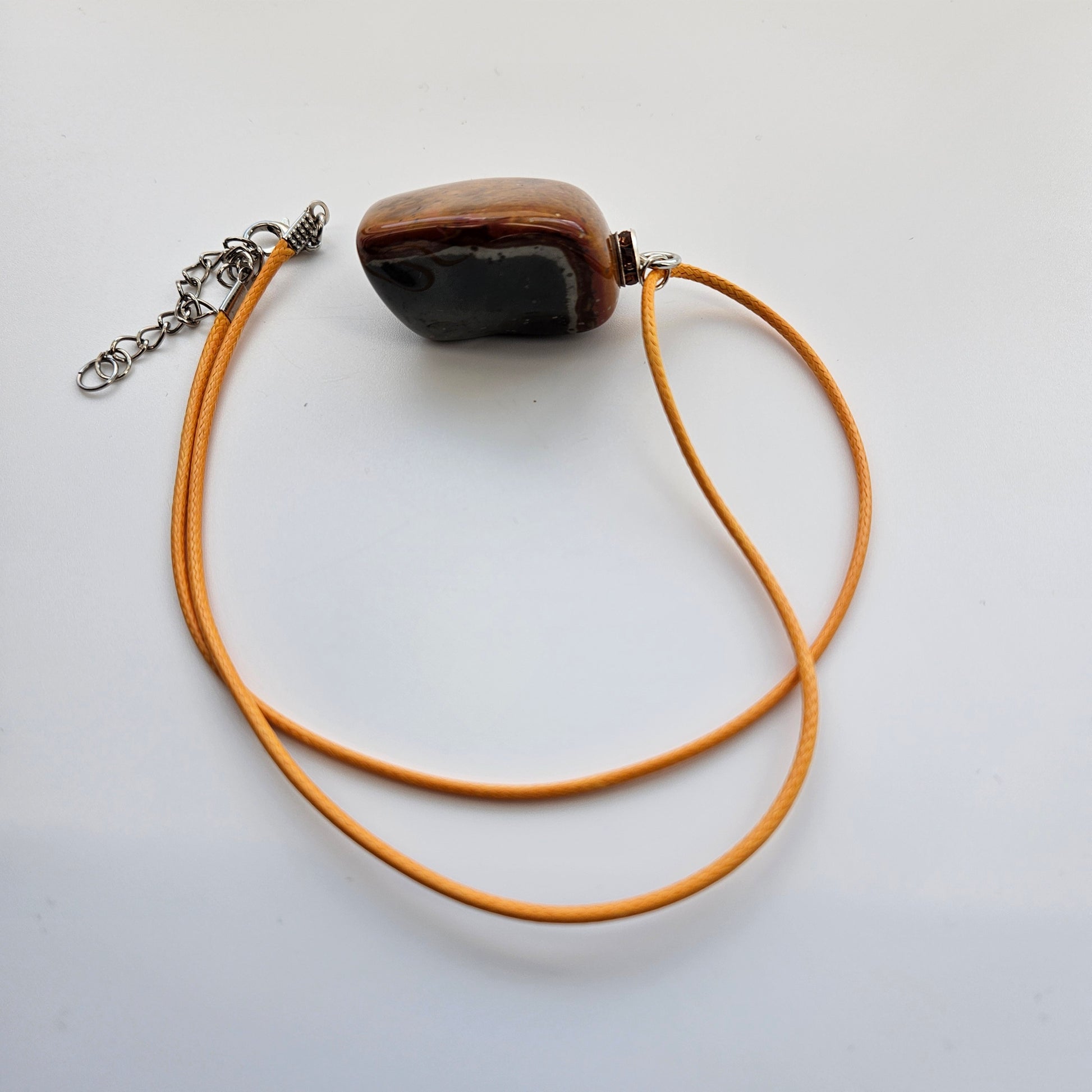 Unique and bold Desert Jasper Pendant with a very intricate color pattern. You will be amazed by its stunning beauty. It is finished with a Yellow Polyester string.