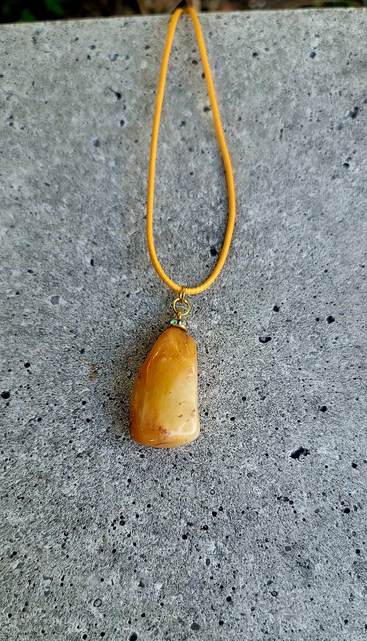 THIS YELLOW AVENTURINE GEMSTONE PENDANT IS SURE TO DELIGHT THE WEARER.