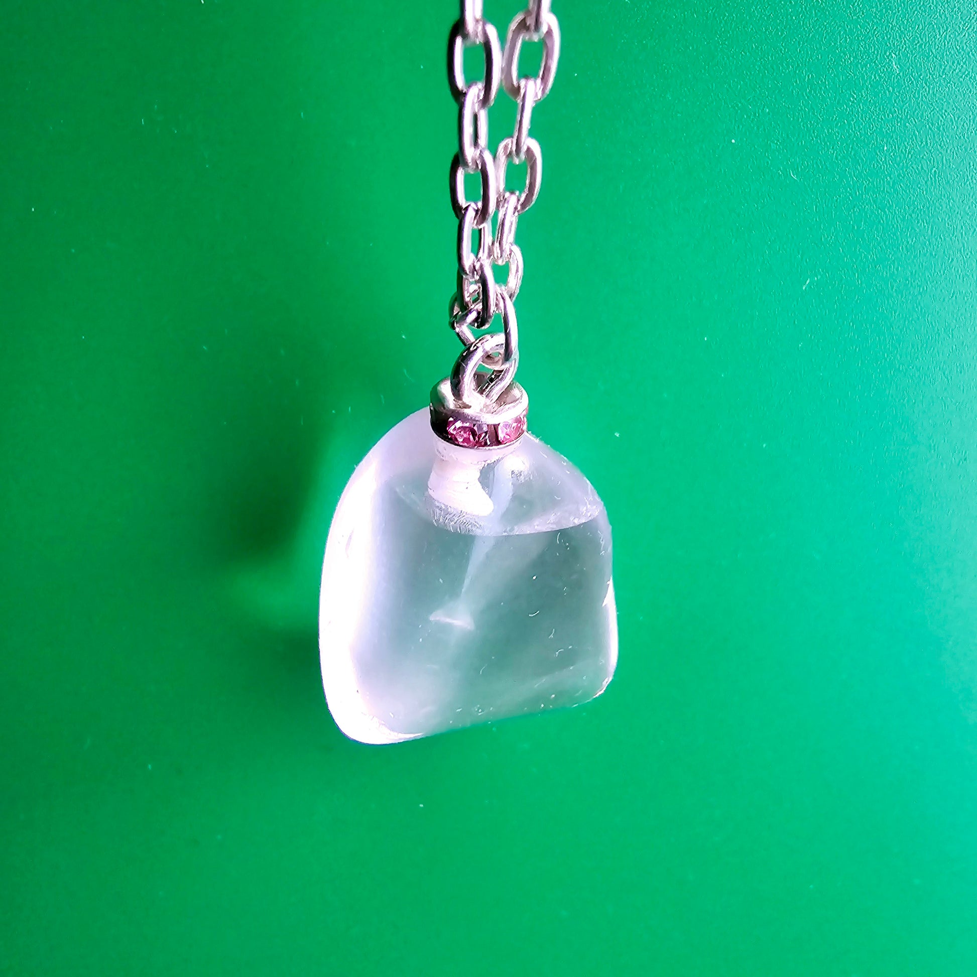 Unique Clear Quartz Pendant that is finished with a 20" Silver-plated chain..