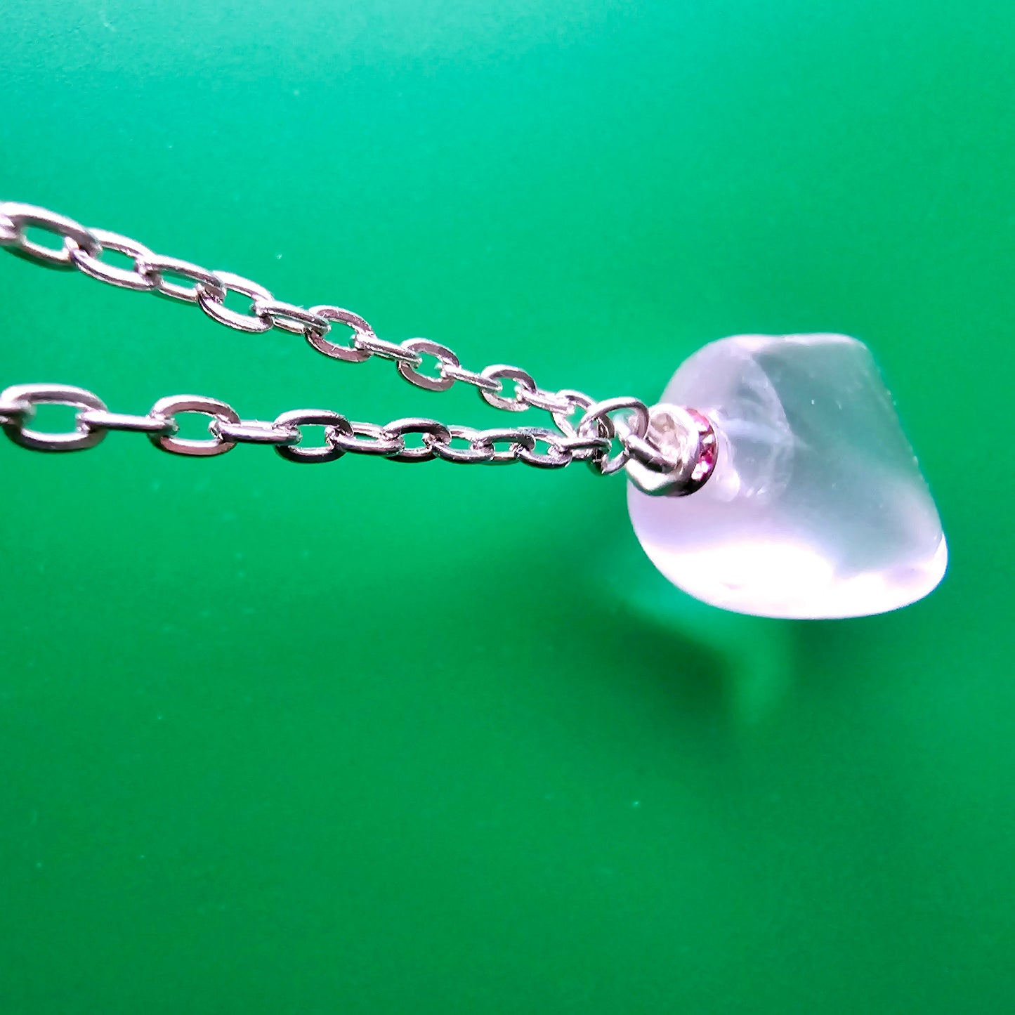 Unique Clear Quartz Pendant that is finished with a 20" Silver-plated chain.