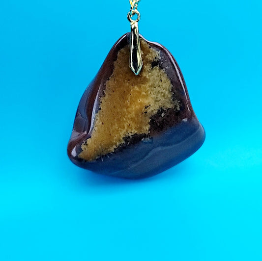 This bold desert jasper pendant is expertly crafted from stunning, natural jasper stone. Its unique, bold design exudes confidence and style, making it the perfect statement piece for any outfit