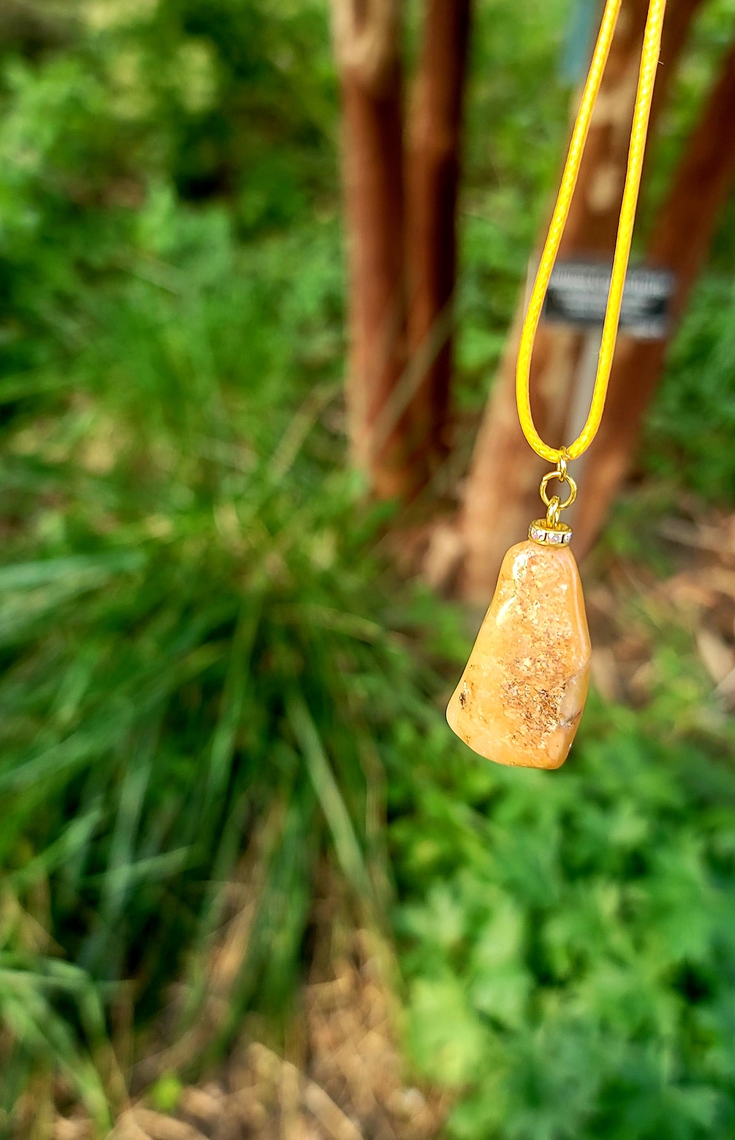 THIS YELLOW AVENTURINE GEMSTONE PENDANT IS SURE TO DELIGHT THE WEARER.