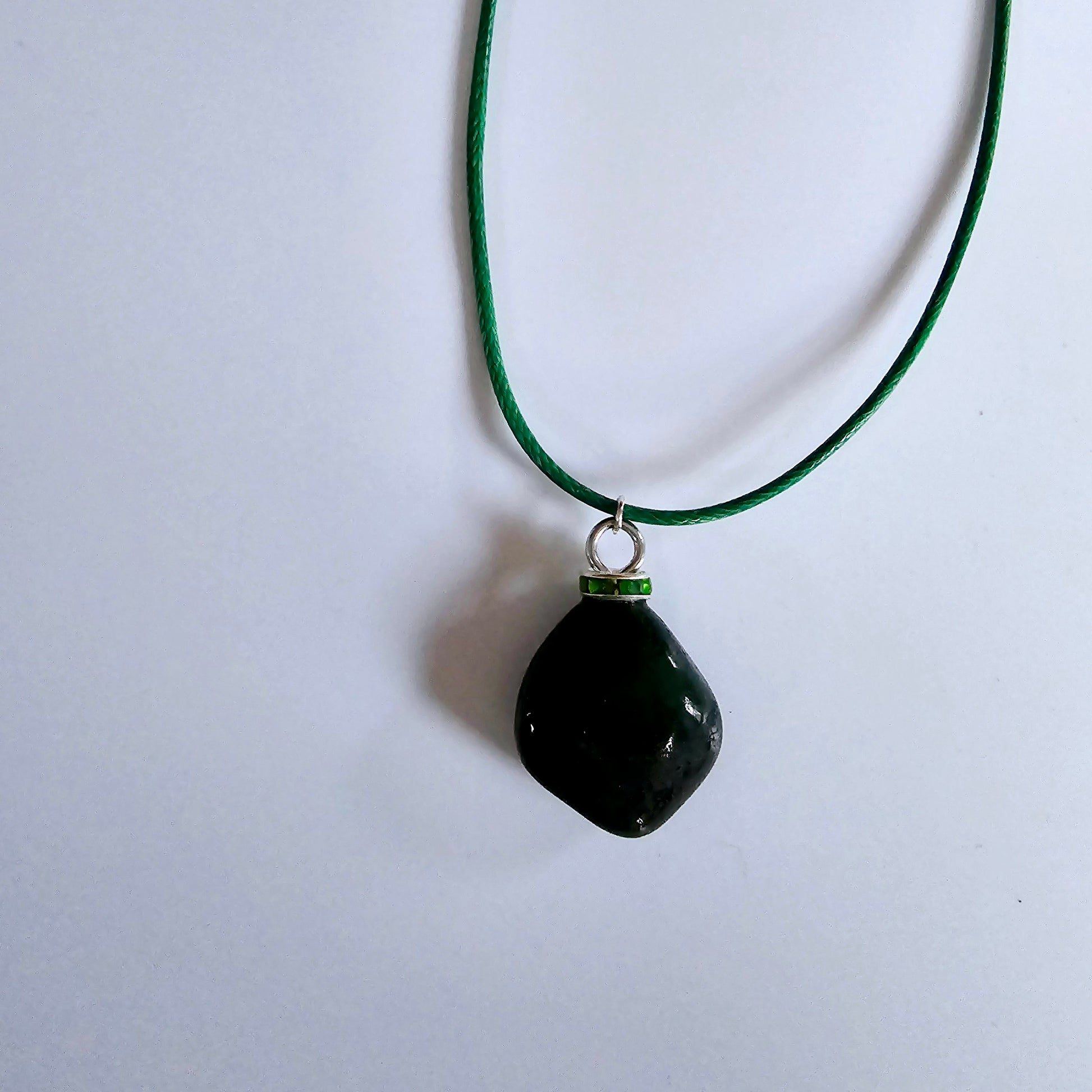 Cute Green Jasper Pendant, trimmed with Plated-Silver findings and an 18" green Polyester string.