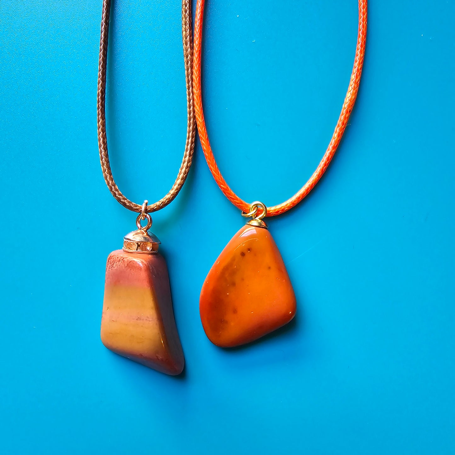 Very vibrant and colorful Jasper pendant that's trimmed with copper findings and an 18" Polyester string. Pictured with another Jasper Pendant.