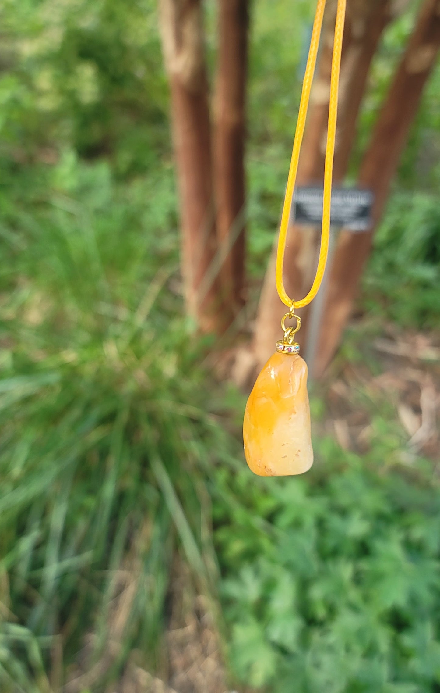 THIS YELLOW AVENTURINE GEMSTONE PENDANT IS SURE TO DELIGHT THE WEARER.