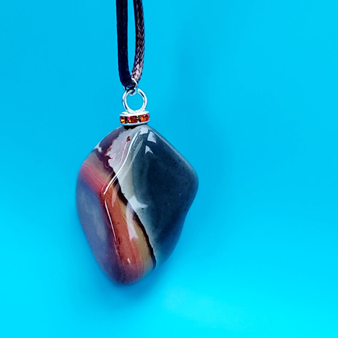 BEAUTIFUL POLYCHROME JASPER PENDANT WITH A STUNNING ARRAY OF COLOR PATTERNS.