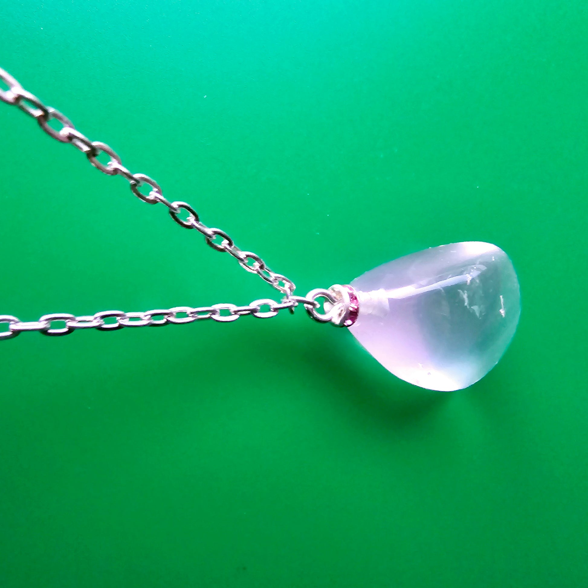 Unique Clear Quartz Pendant that is finished with a 20" Silver-plated chain.