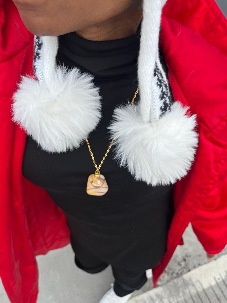 Bold, multicolored Desert Jasper Pendant. This pendant has a vivid color pattern consisting of Yellow, Brown and Purple as the main colors. Lifestyle picture shown of pendant being worn.