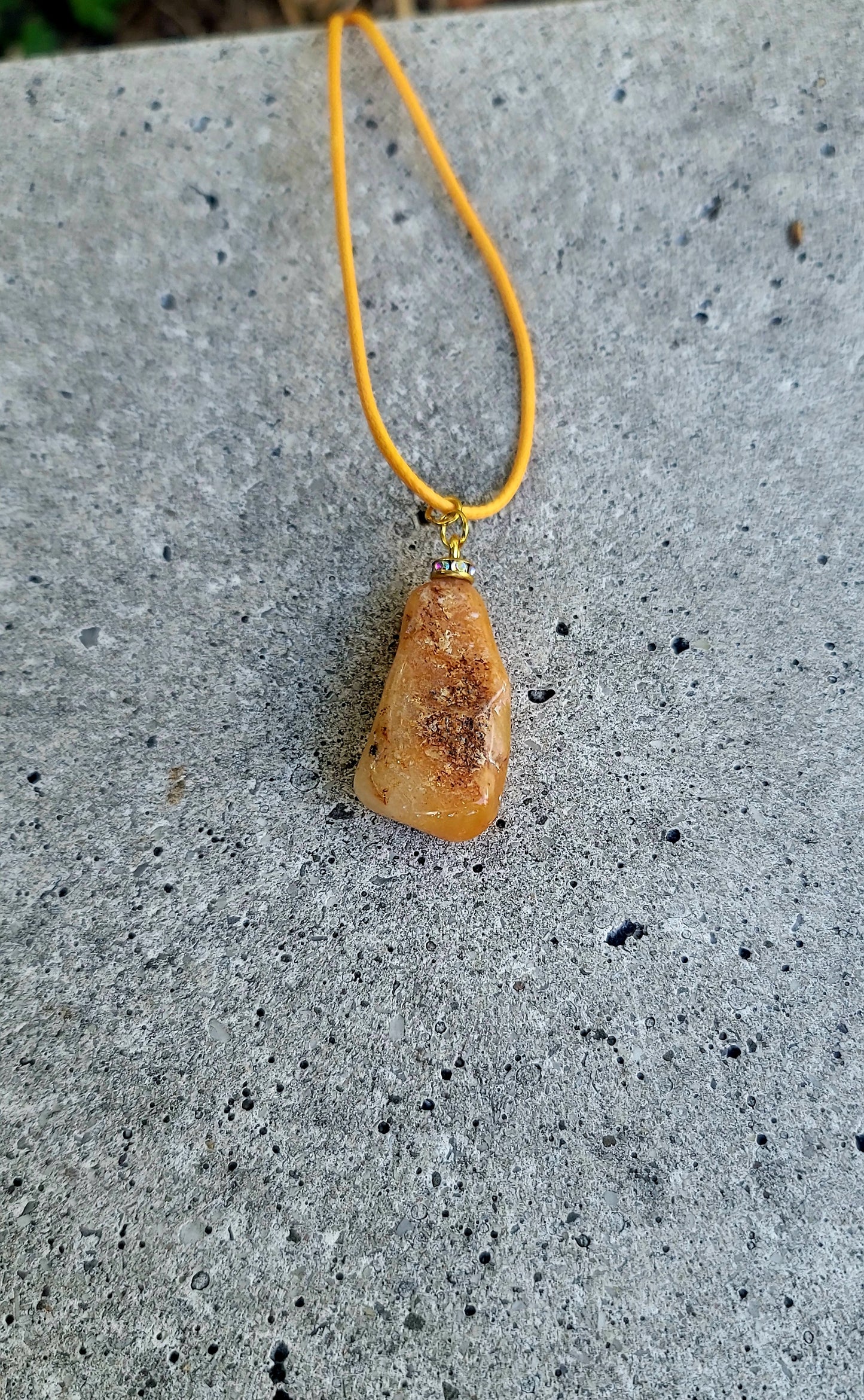 THIS YELLOW AVENTURINE GEMSTONE PENDANT IS SURE TO DELIGHT THE WEARER.