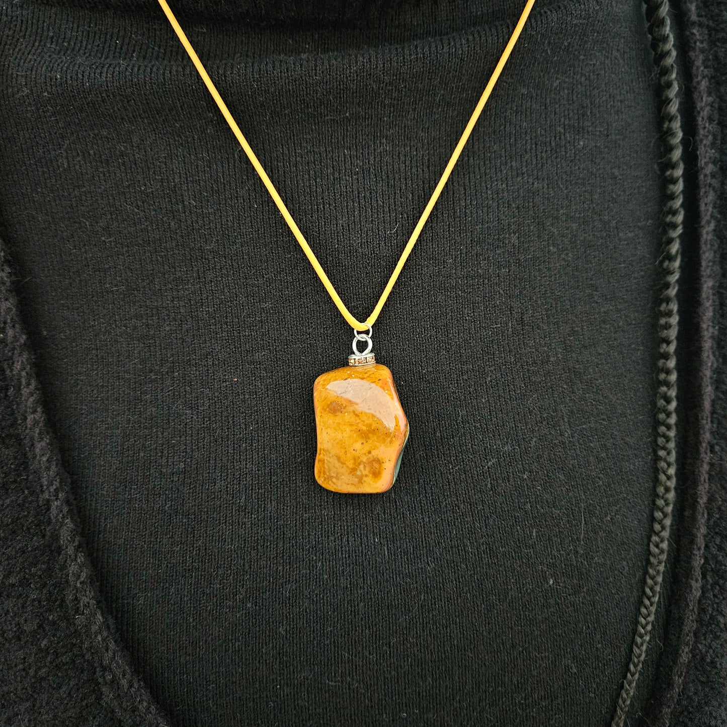 Unique and bold Desert Jasper Pendant with a very intricate color pattern. You will be amazed by its stunning beauty. It is finished with a Yellow Polyester string.