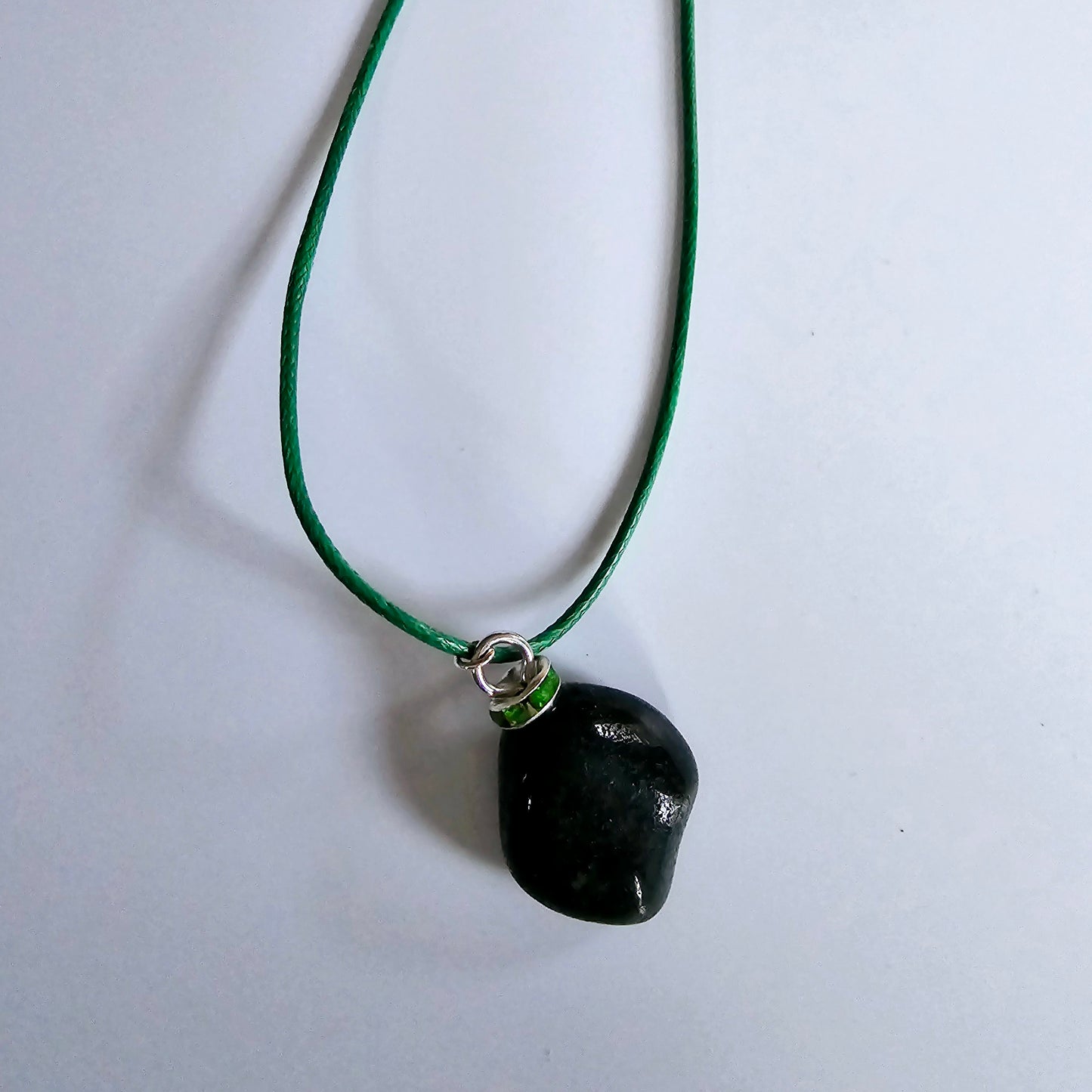 Cute Green Jasper Pendant, trimmed with Plated-Silver findings and an 18" green Polyester string.